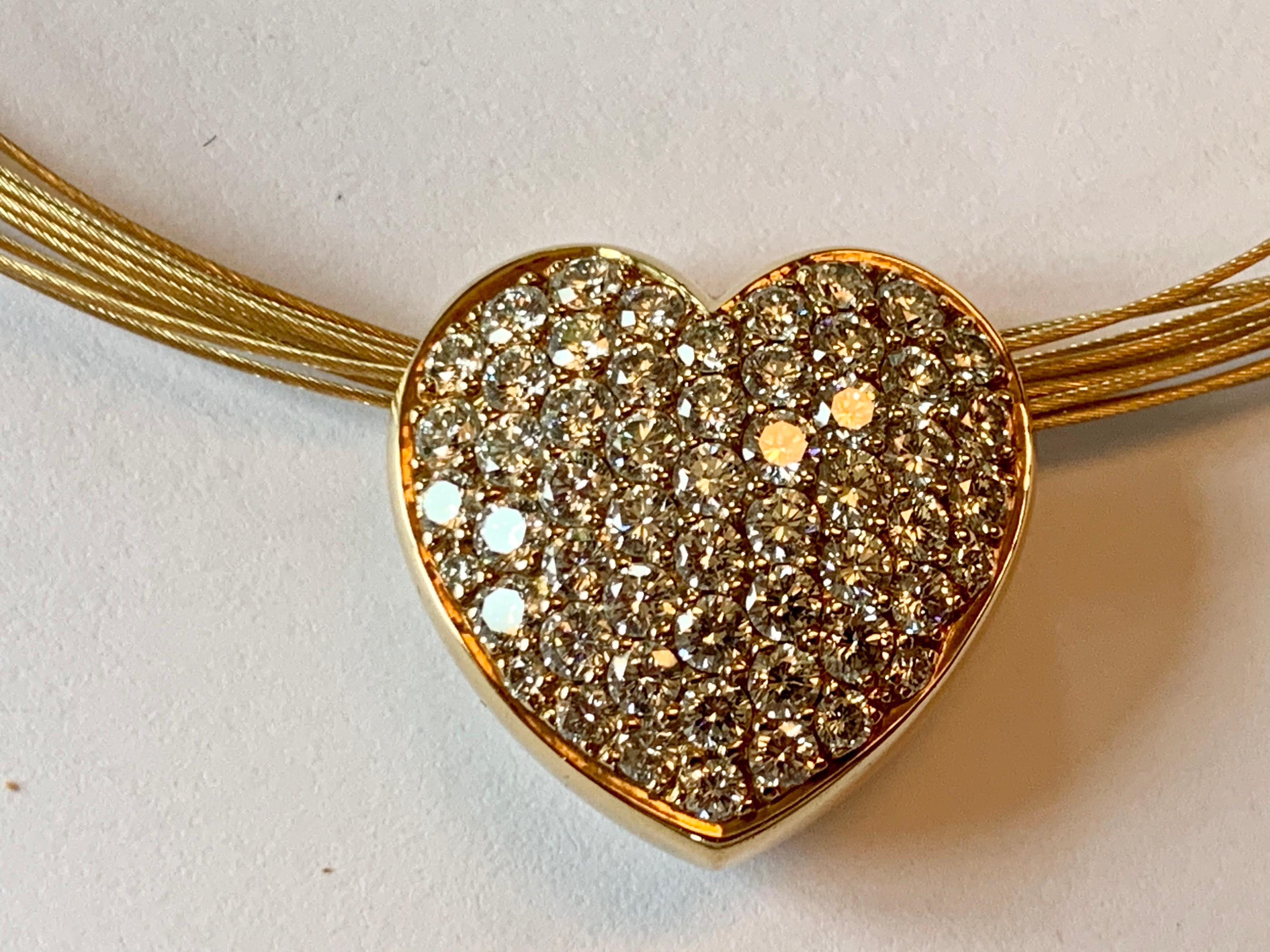 A timeless and yet very wearable multi-strand gold wire necklace with a hear pendant. In 18 K yellow Gold. 
The heart is pave set with an incredible assortment of brilliant cut Diamonds weighing 4.05 ct,  E color, vs clarity. 
Length: 41 cm. 