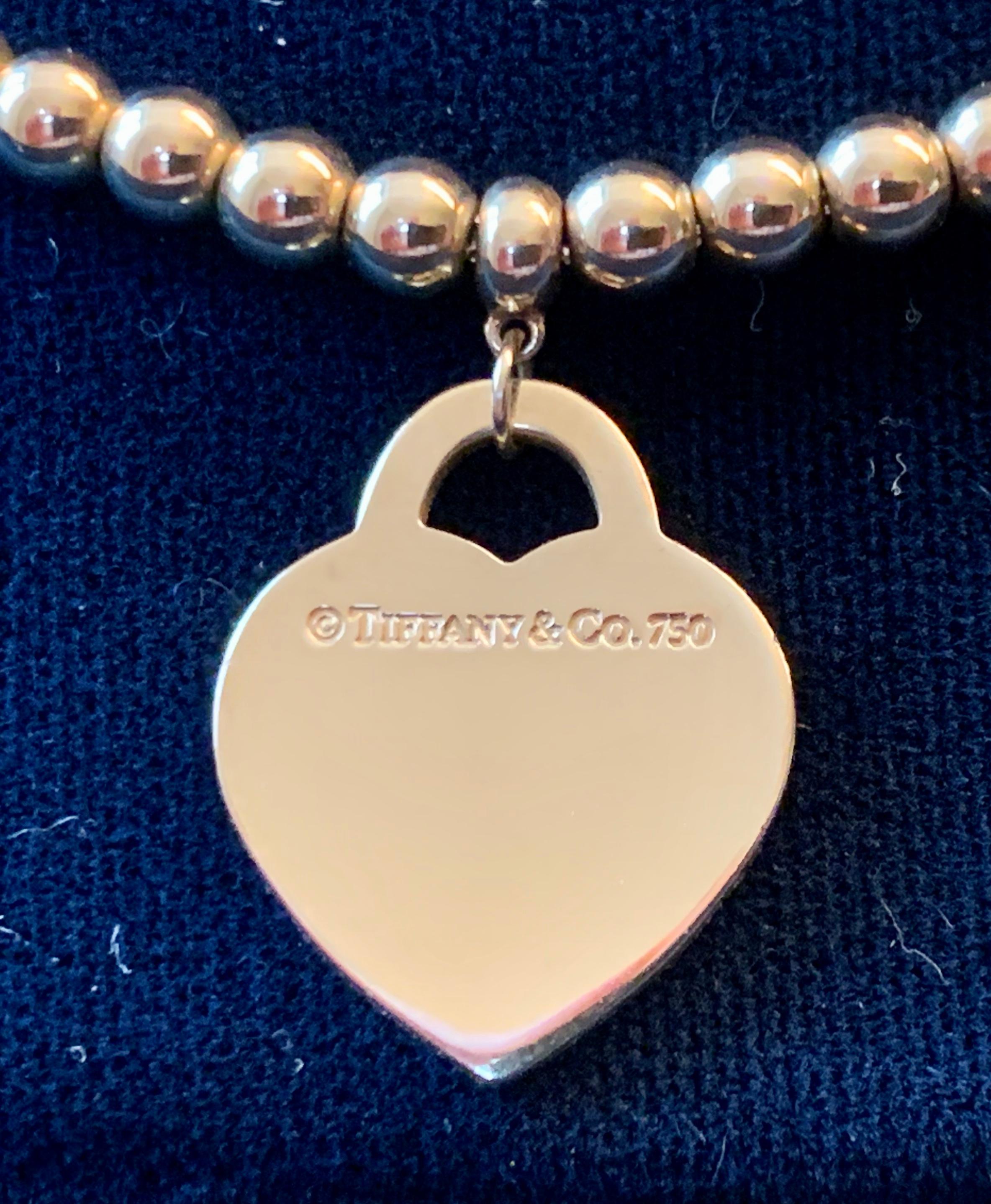 This Return to Tiffany & Co. yellow Gold  Heart Ball / Bead necklace is a Tiffany classic that will never go out of style.  The piece makes a 