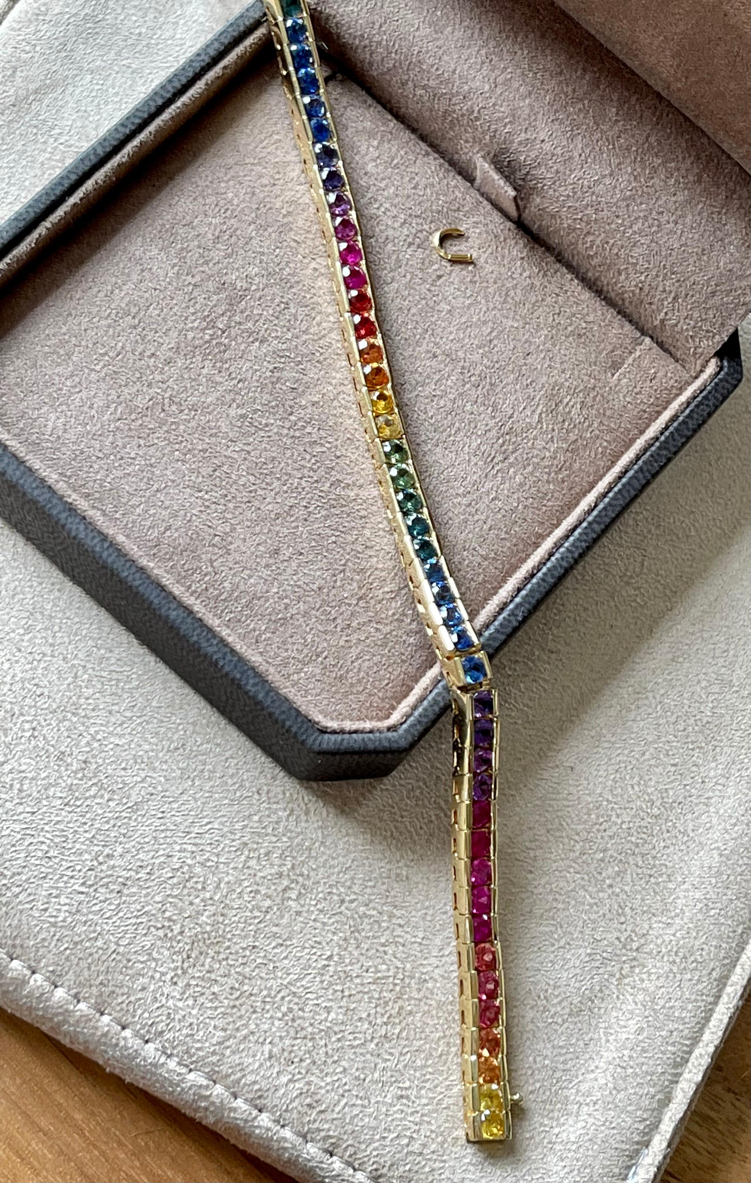 This stunning bracelet is made in 18 K yellow Gold and set with brilliant cut Raninbow Sapphires. 
Dimensions: Bracelet is 18 cm long and 0.5 cm wide. 
Masterfully handcrafted piece! Authenticity and money back is guaranteed.
For any enquires,