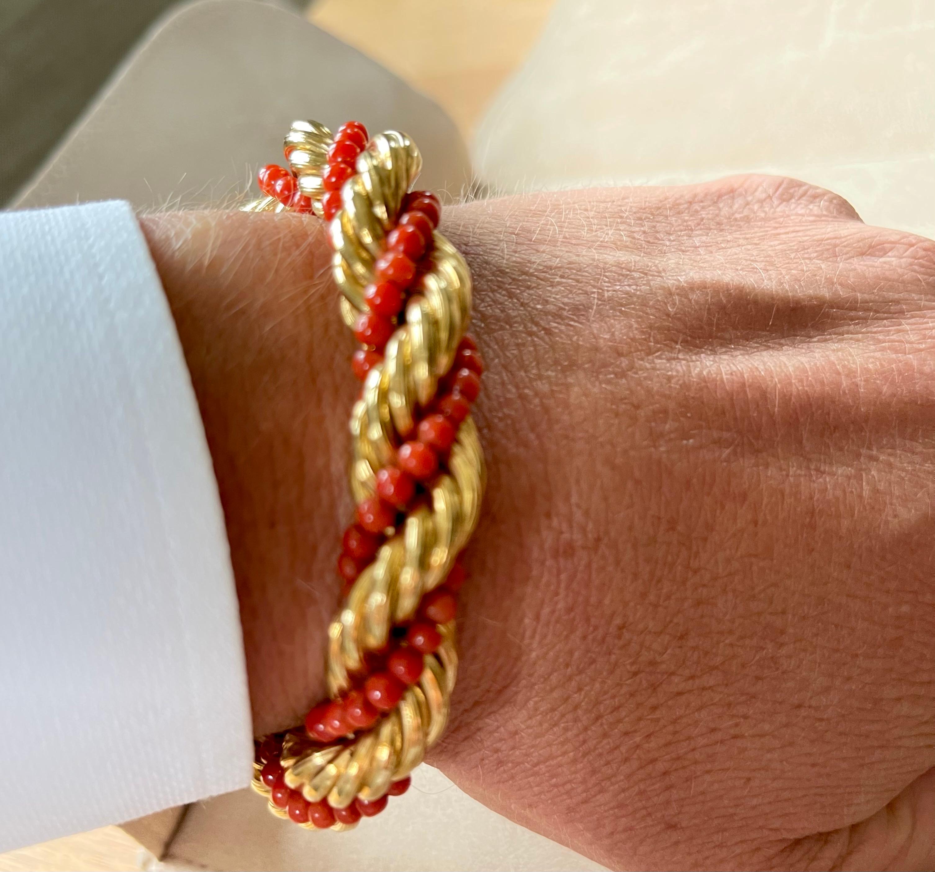 Rare 18 K yellow Gold Torsade featuring a twisted gold chain and deep red coral bead chain that create a unique Vintage  bracelet. Length: 19.5 cm. 
Matching necklace available. 
Masterfully handcrafted piece! Authenticity and money back is