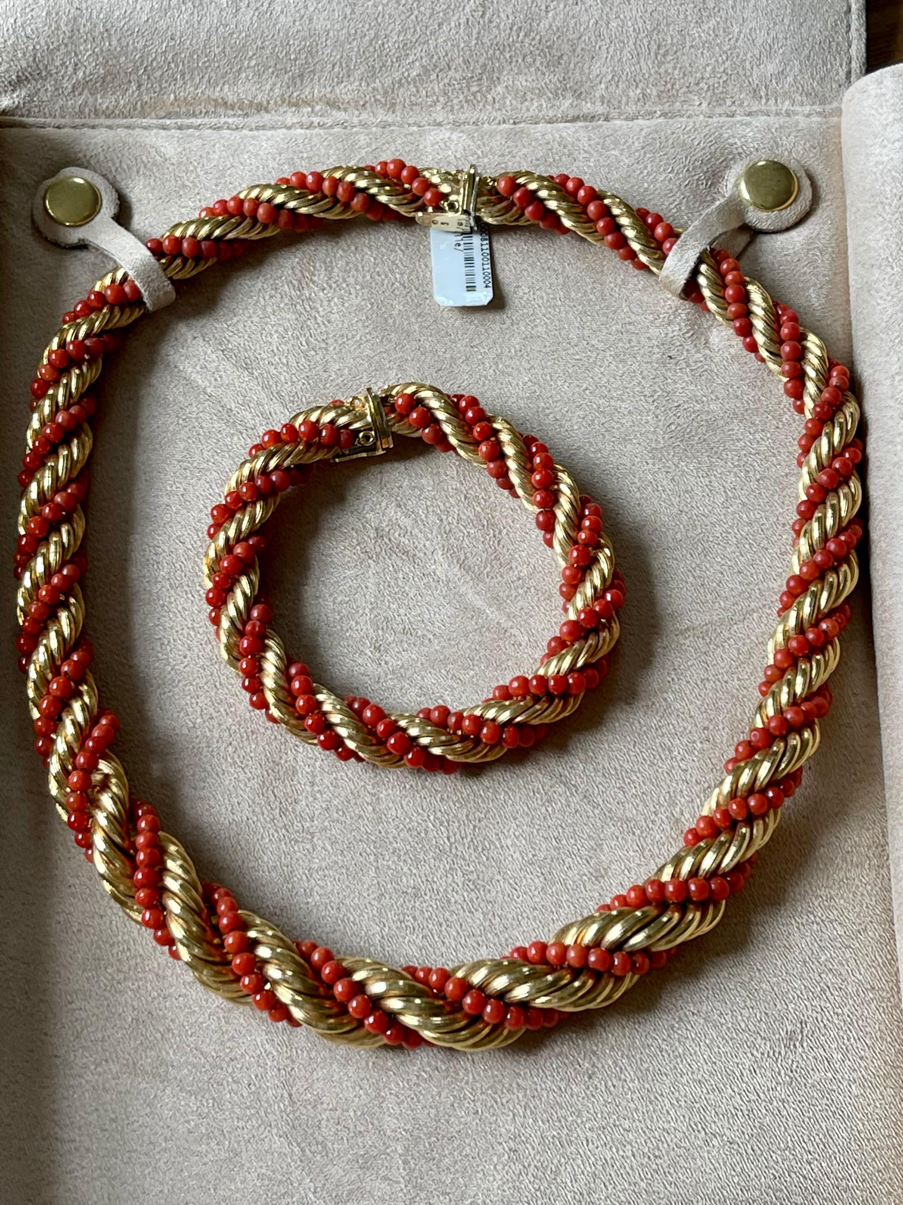 Rare 18 K yellow Gold Torsade featuring a twisted gold chain and deep red coral bead necklace. It can be worn at two different lengths, 43 cm and 61 cm, or the extension part can be also worn as a bracelet (length 18 cm). 
Masterfully handcrafted