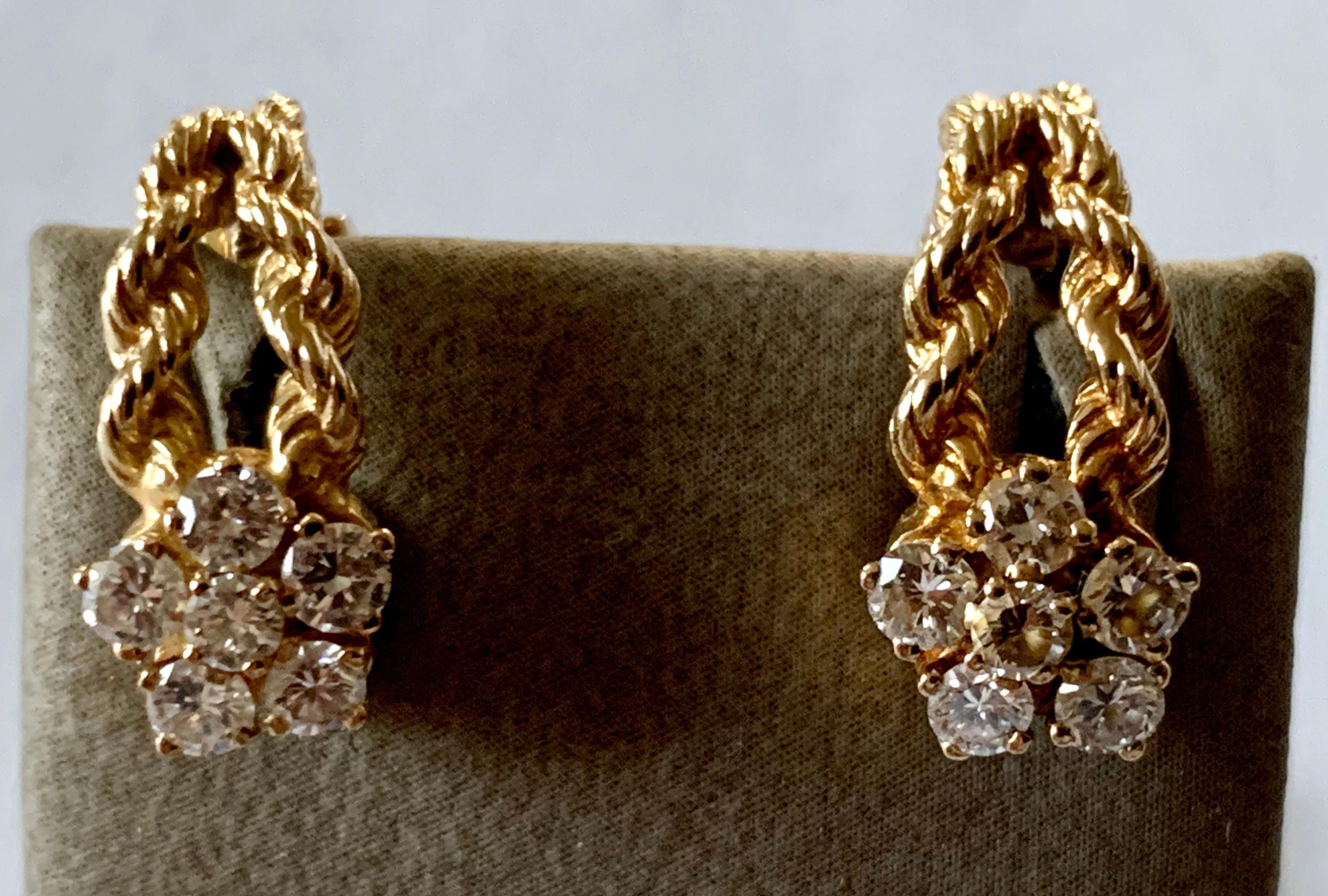 A pair of 18 K yellow Gold rope twist gold and diamond clip earrings of knotted design. The top part showcases 6 brilliant cut Diamonds set in a floral motif design. Total weight of the 12 brilliant cut Diamonds is approximately 1 ct.