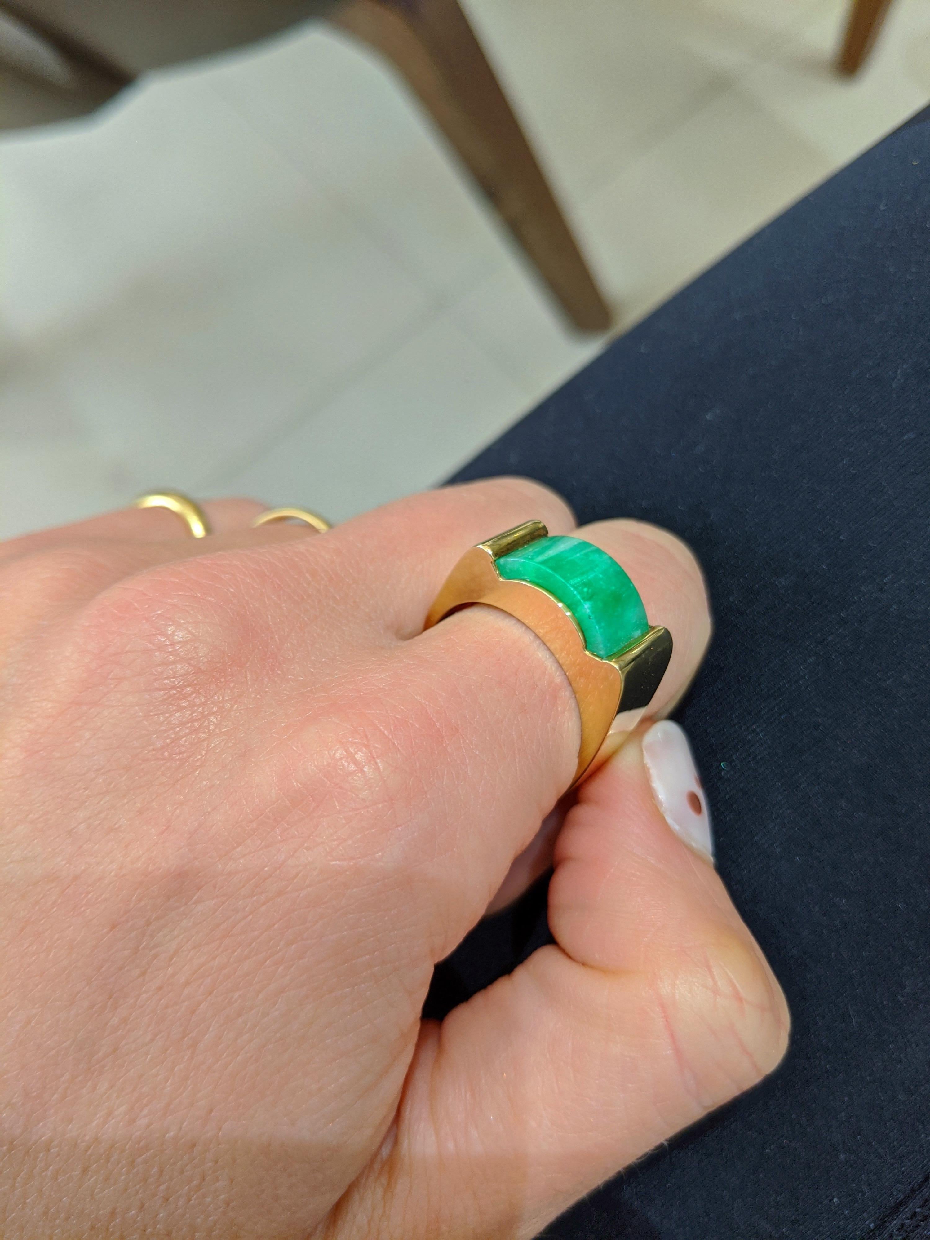 18 Karat yellow gold ring . The center section of this ring is set with a beautiful  Green Jade curved section. The ring has a squarish shank. 
Finger size 9 3/4  
Stamped 18K