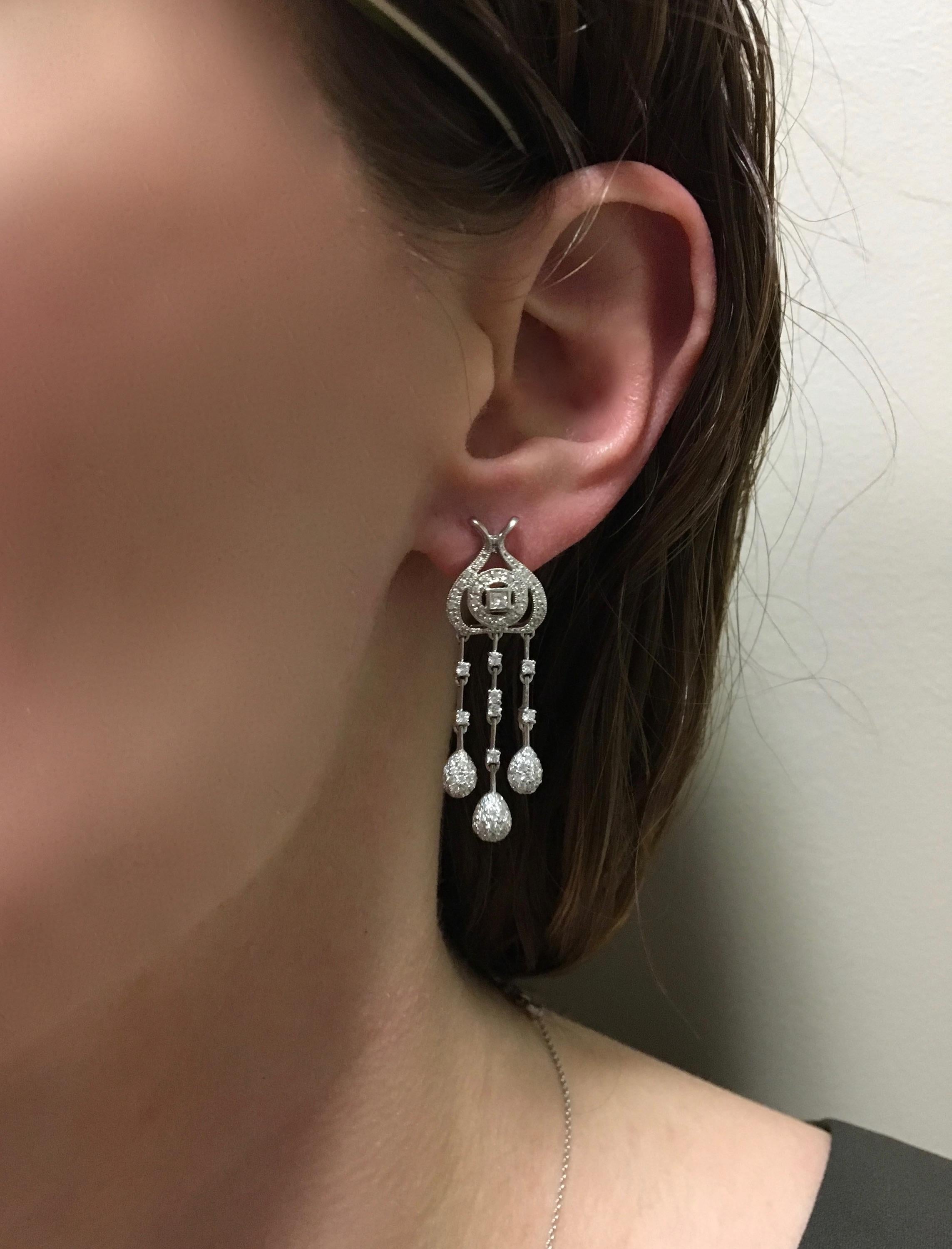 These elegant 18K white gold chandelier style dangle earrings feature approximately 1.07CTW of Diamonds.

Diamond Carat Weight: Approximately 1.07CTW
Diamond Cut:  Round Brilliant Cut Diamonds and Two Princess Cut Diamonds
Color: Average