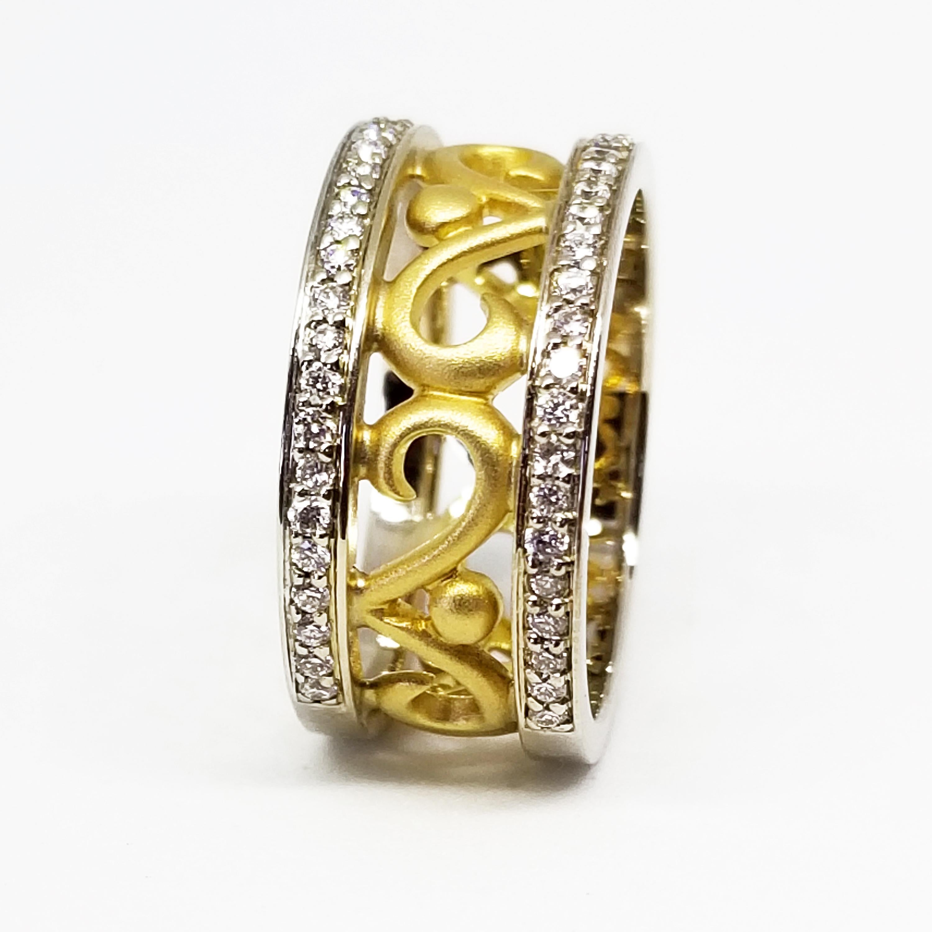 This 18 Karat Gold Eternity Ring features Round Brilliant Diamonds of 0.66 Carat total weight, G Color and Vs-Si1 Clarity, and are bead set on each outer band of the ring. The Highly Polished outer bands of the ring are 18 Karat White Gold and are
