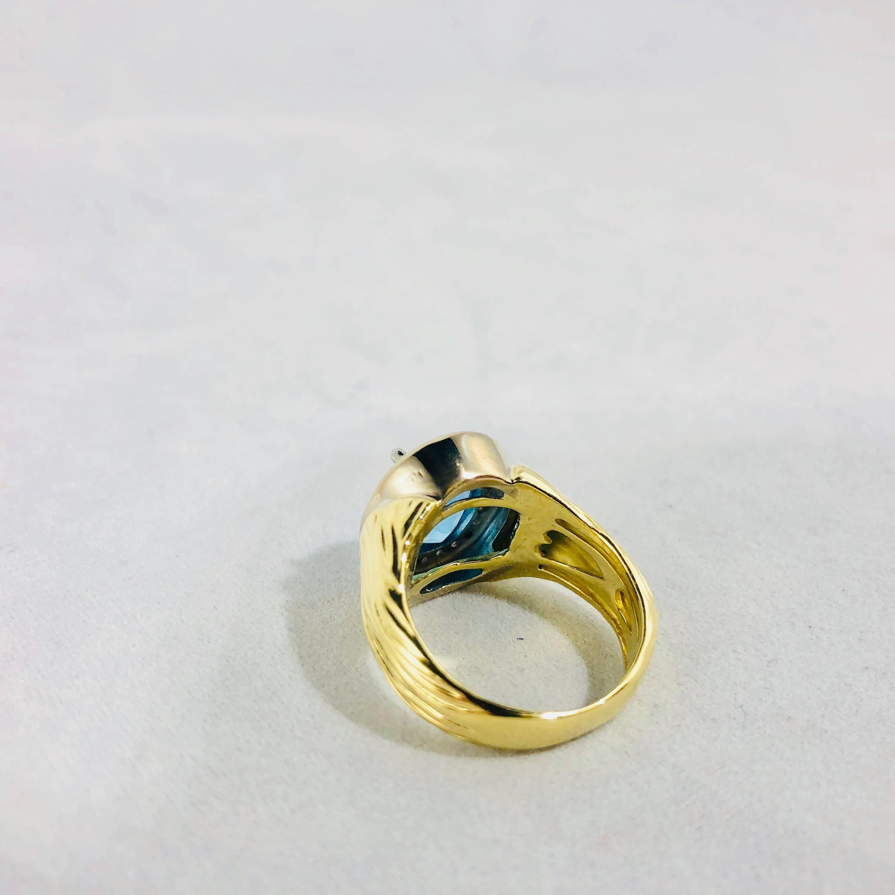 Modern 18 Karat Two-Tone Yellow and White Gold Blue Topaz and Diamond Cocktail Ring