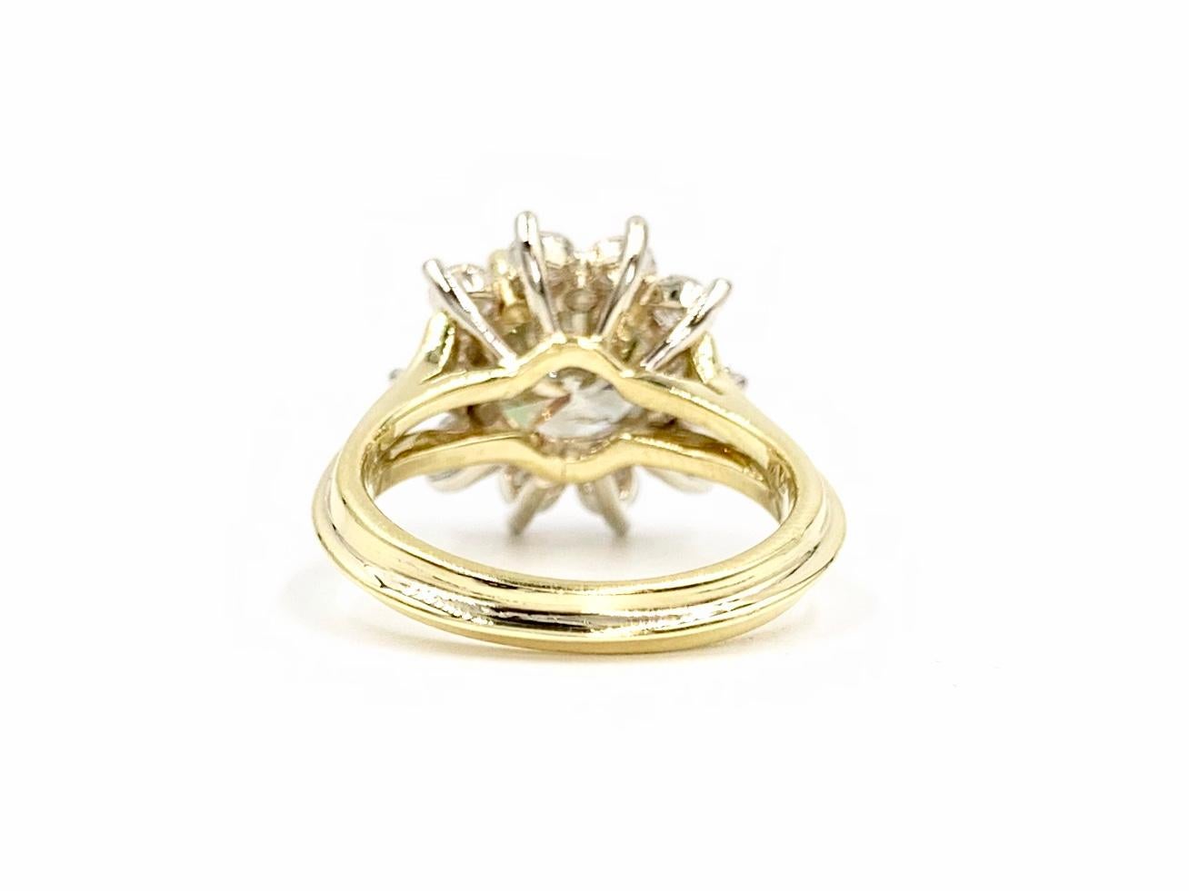 Priced to sell! A timeless and elegant 18 karat yellow gold halo ring featuring a 2.51 carat champagne/bronze round brilliant diamond center surrounded by 10 round brilliant white diamonds at 1.50 carats total weight. Ring is designed with a