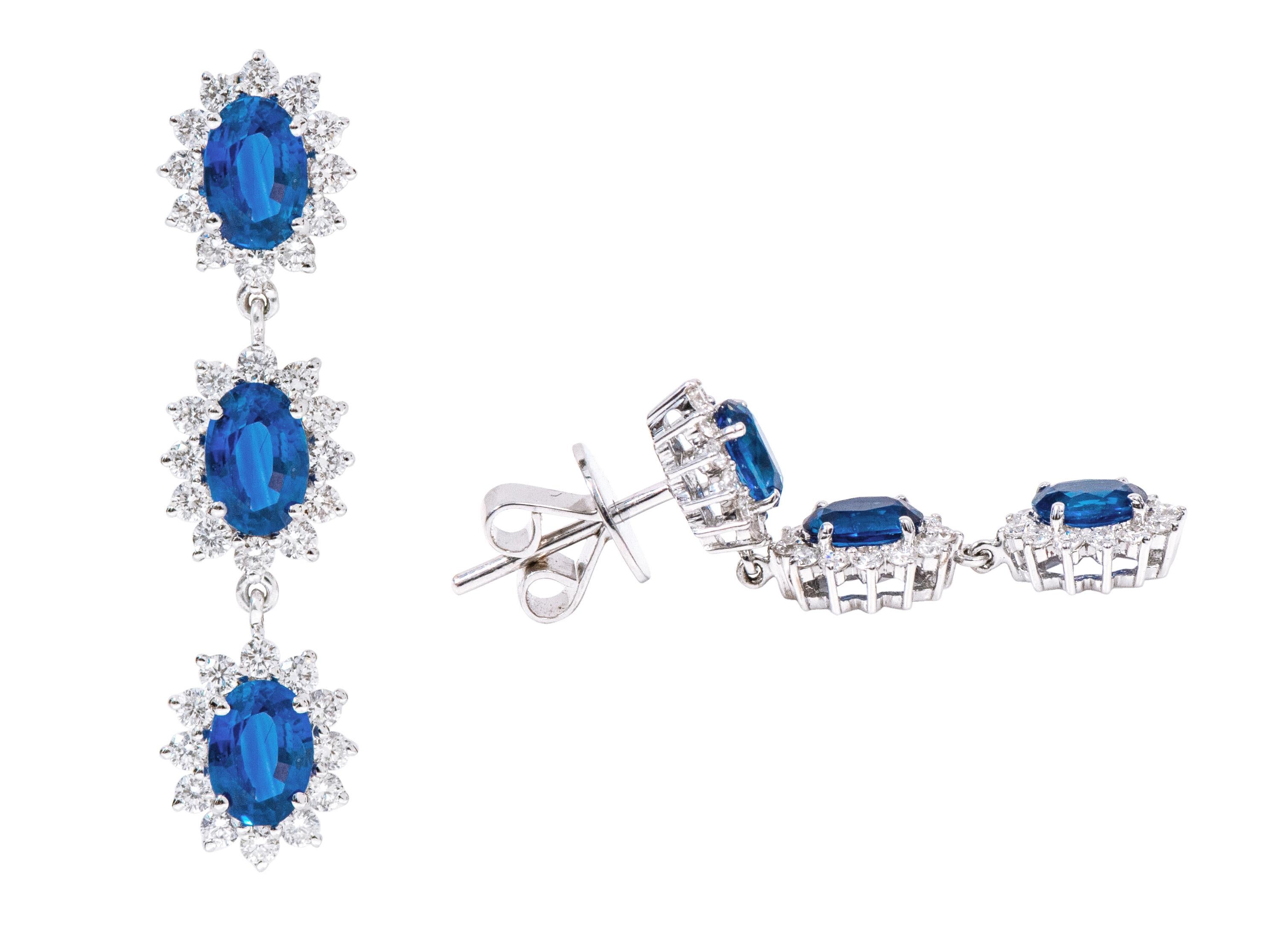 18 Karat 4.13 Carat Sapphire and Diamond Cluster Drop Earrings

This exemplary azure blue sapphire and diamond long earring is regal. The fantastic three rows of solitaire oval sapphires are surrounded by the outward facing open cluster of 3-prong