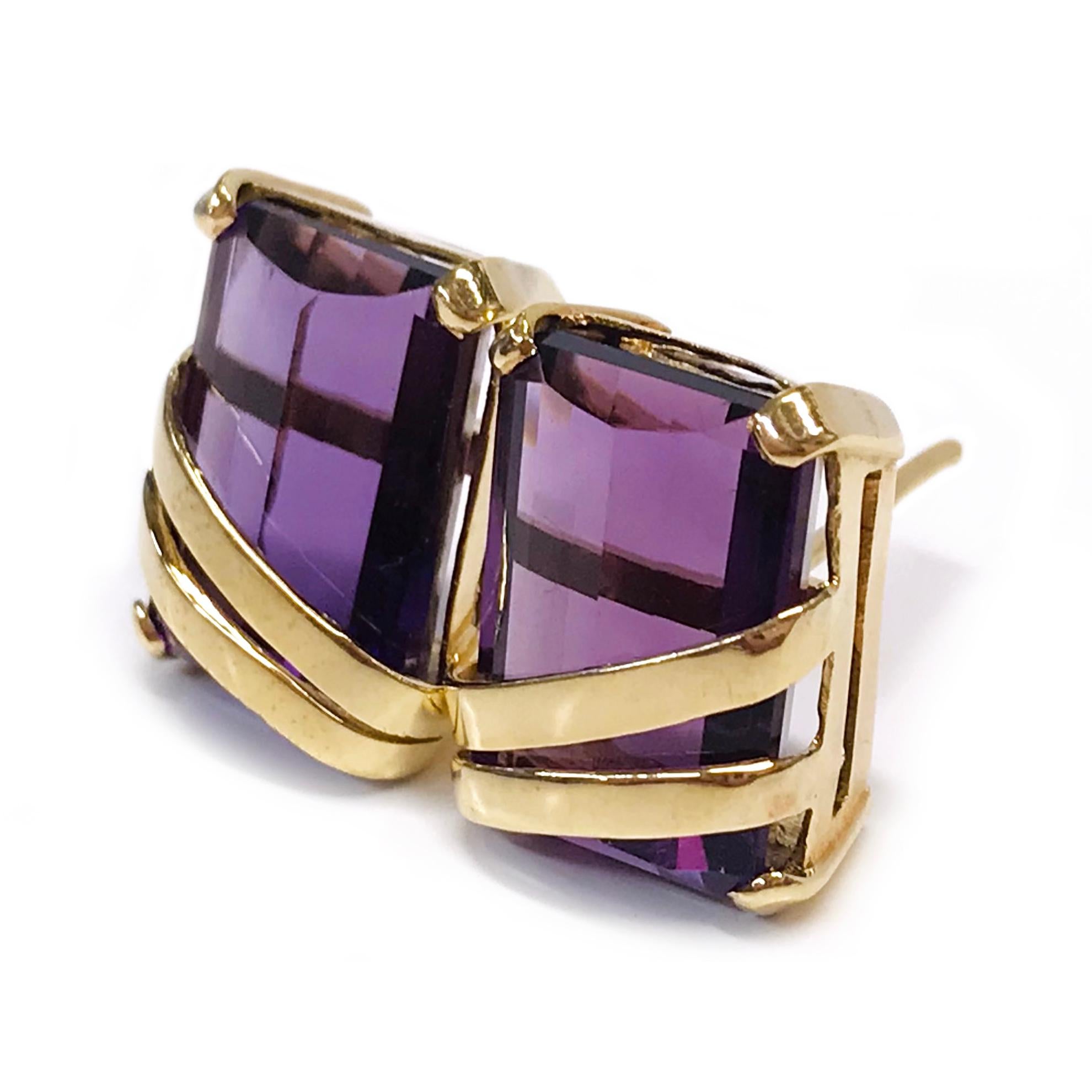 18 Karat Amethyst Stud Earrings. The earrings each feature a 14.3 x 10.2 x 6.3mm emerald-cut Amethyst stone. The Amethyst's are dark medium in color and both earrings have a combined total carat weight of 15.0tcw. The gemstones are three-prong-set