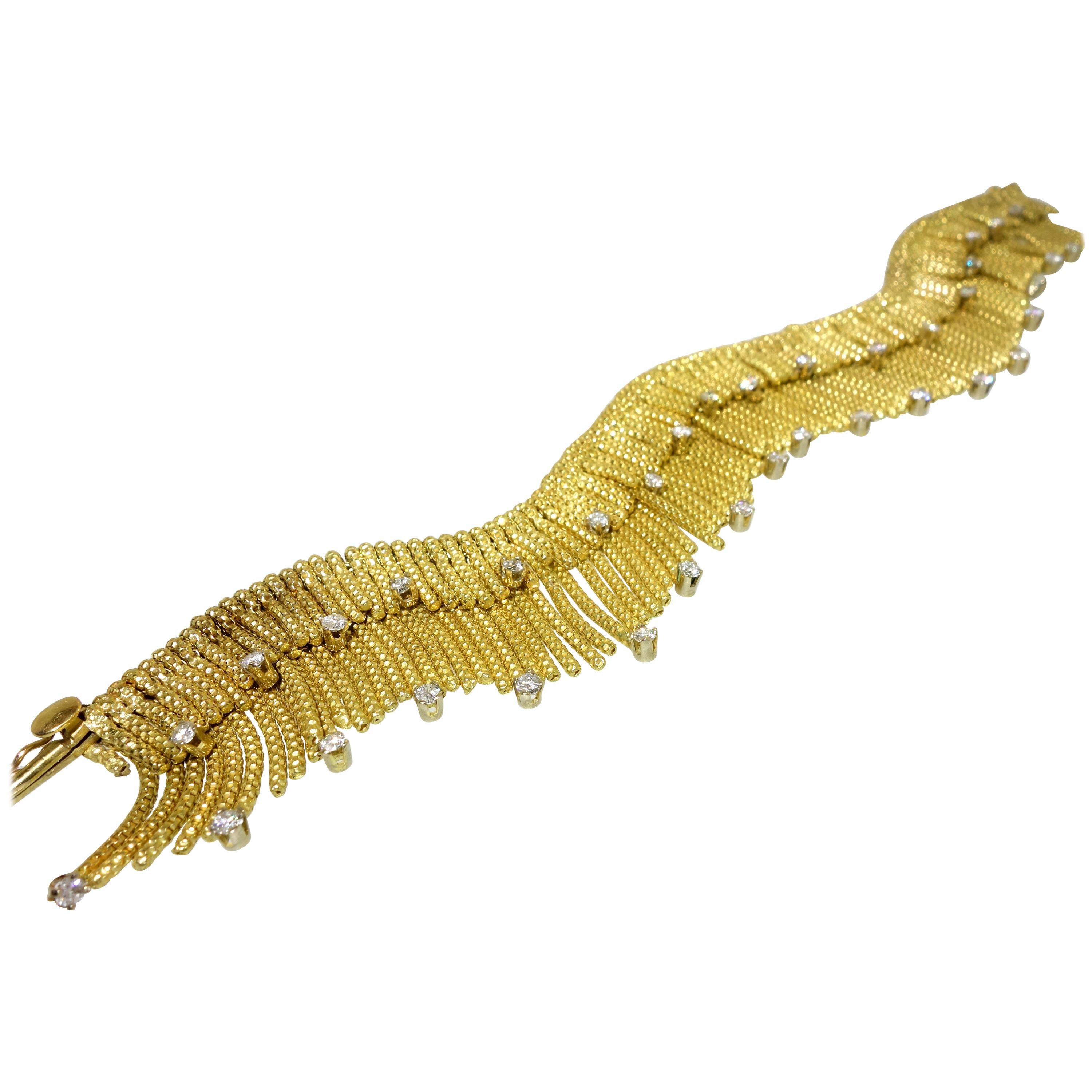 Retro design 18K and diamond fringe bracelet.  Outrageous in design, this bracelet is a heavy 18K gold long bracelet set with diamonds throughout the fringe.  The bracelet weighs 69.32 grams and is just over 7.5 inches long and 1 inch wide. 