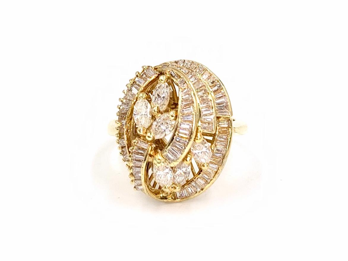 Circa 1960. This 18 karat yellow gold vintage swirl ring consists of approximately 1.10 carats of baguette and marquise cut diamonds. Ring has an airy and feminine appearance. Diamond quality is approximately G-H color, SI1 clarity.
Top section of