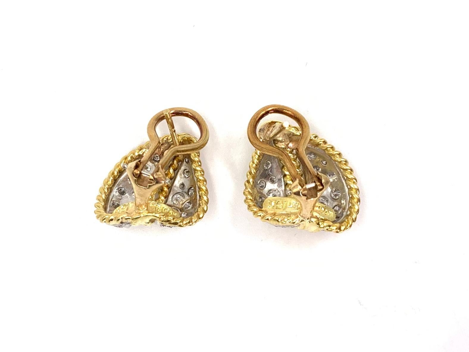 Timeless and elegant 18 karat yellow gold and platinum diamond leaf huggie style earrings featuring approximately .60 carats of white diamonds. Diamond quality is approximately F-G color, VS2 clarity. Perfect for every day wear.
Earrings are fixed