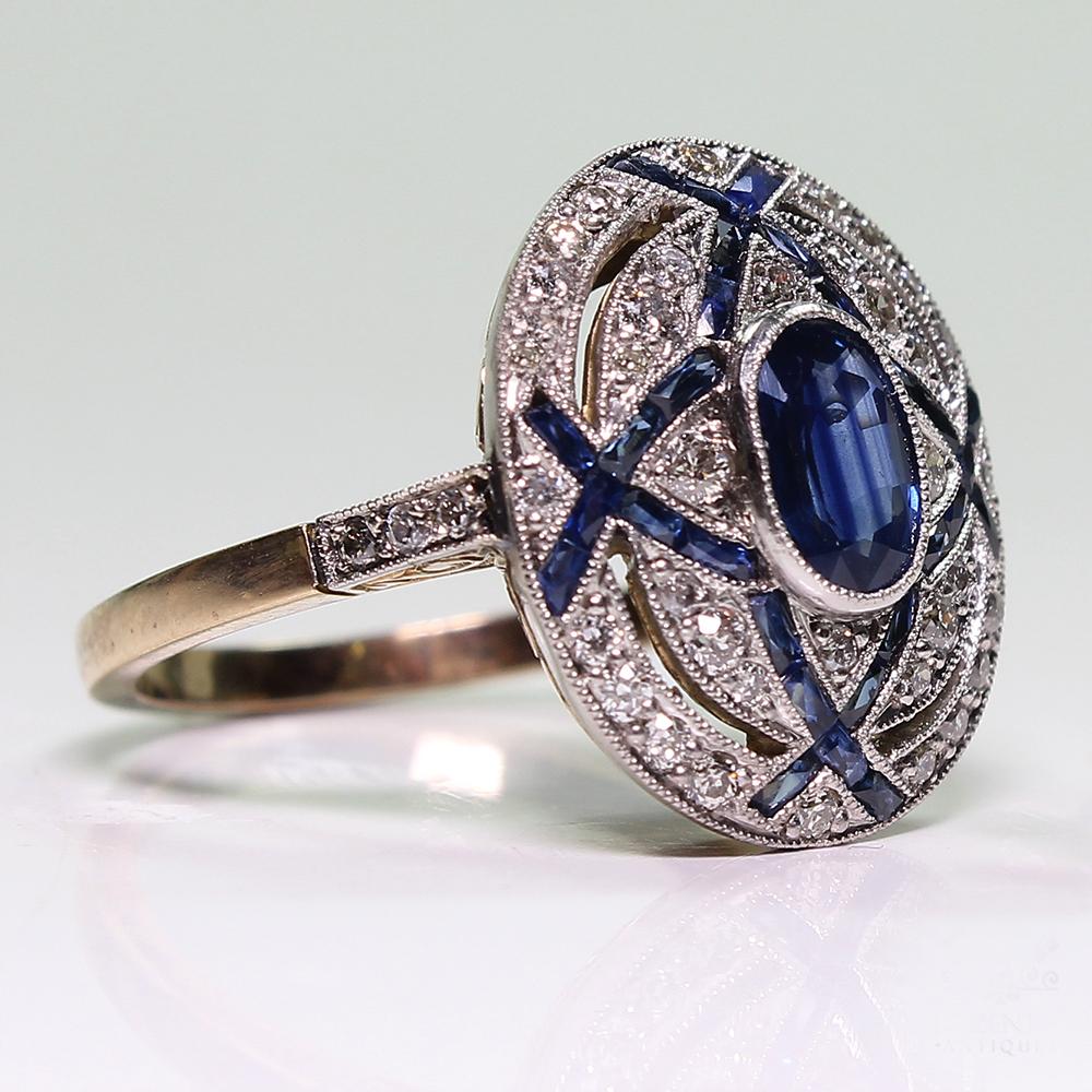 Period: Art Deco (1920-1935)
Composition: Platinum
Stones:
•	1 natural oval cut sapphire that weighs 1.15ctw.
•	46 Old mine cut diamonds of H-VS2 quality that weigh 0.50ctw. 
•	32 natural calibrated French cut sapphires that weigh 0.50ctw.
Ring
