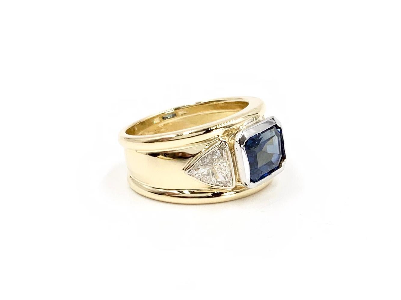 Emerald Cut 18 Karat and Platinum Three-Stone Blue Sapphire and Diamond Wide Ring For Sale