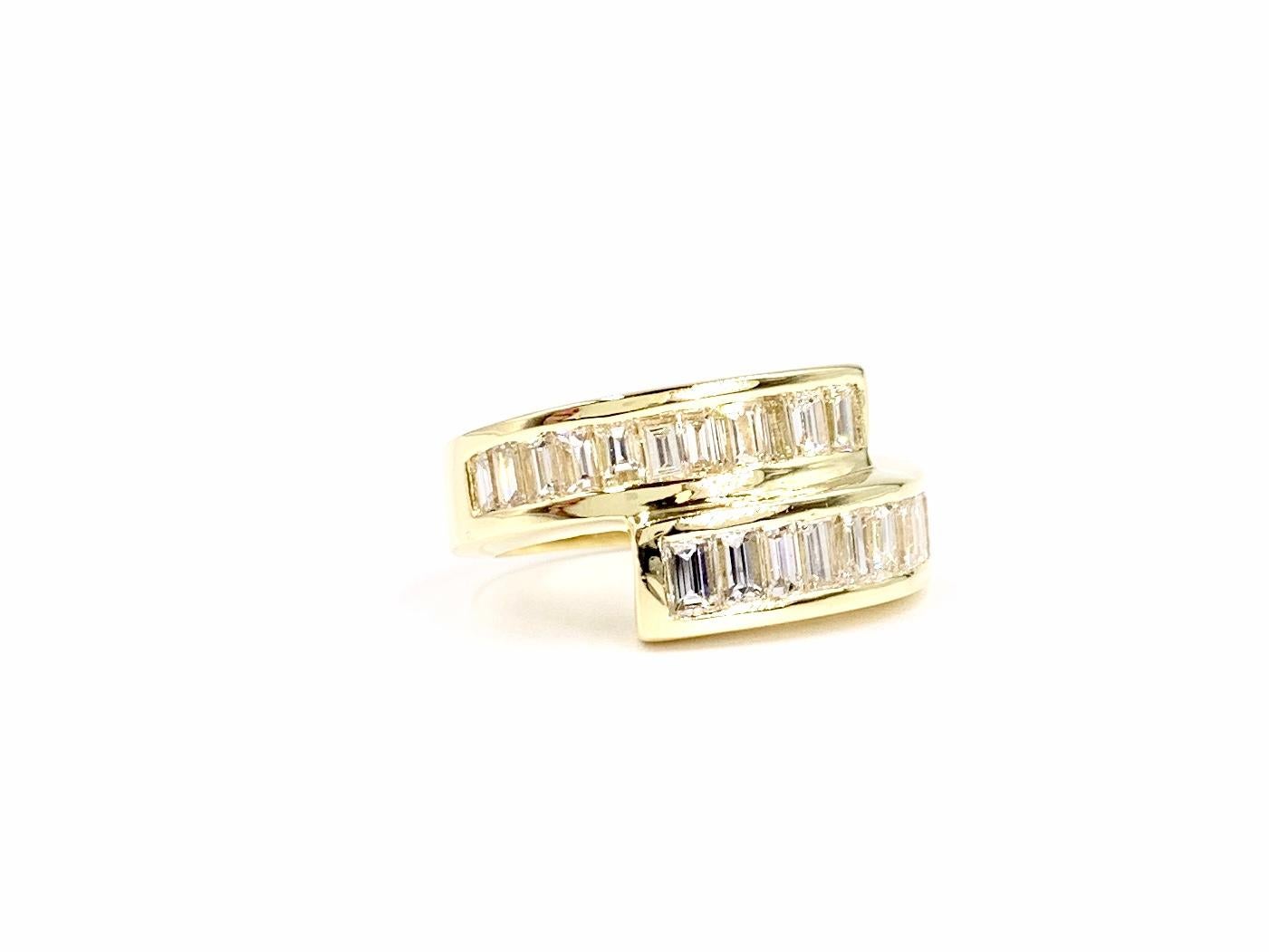 A sleek and wearable polished 18 karat yellow gold wrap around bypass style ring featuring 21 beautifully channel set baguette diamonds at approximately 3.50 carats total weight. Diamond quality is approximately H color, VS2 clarity. Width of ring