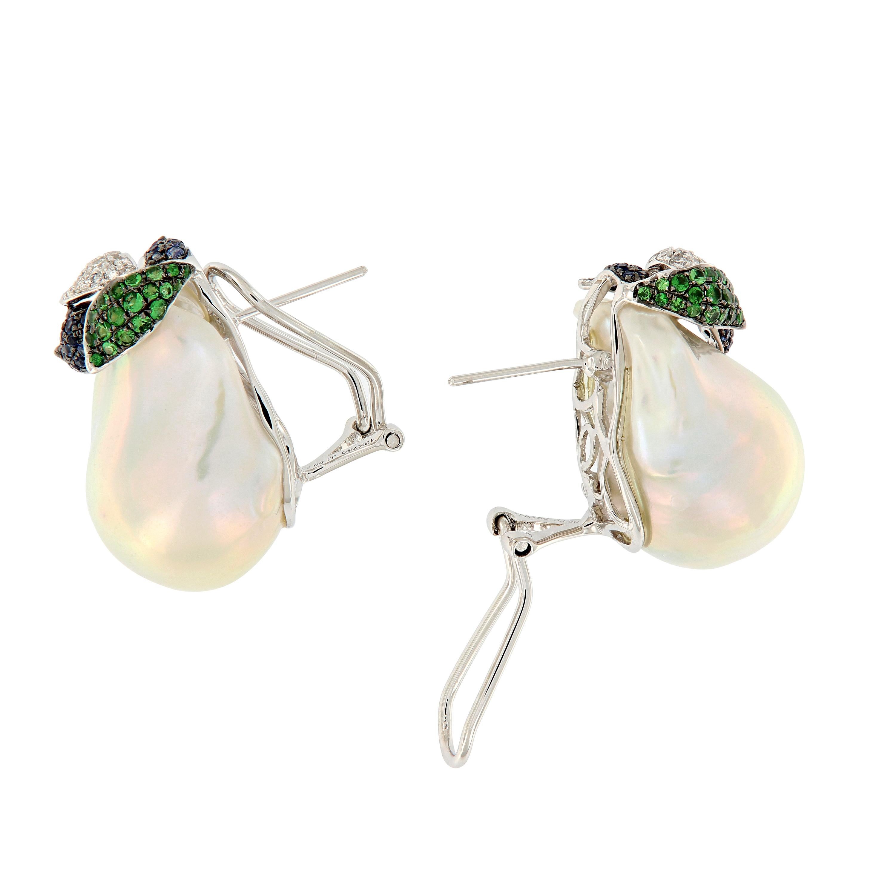 Outstanding large fresh water baroque pearls accented with leafs of blue sapphires, tsavorites and diamonds. Earrings hand crafted in 18k white gold with omega backs.

Sapphires 0.49 cttw
Tsavorite 0.65
Diamonds 0.28 cttw