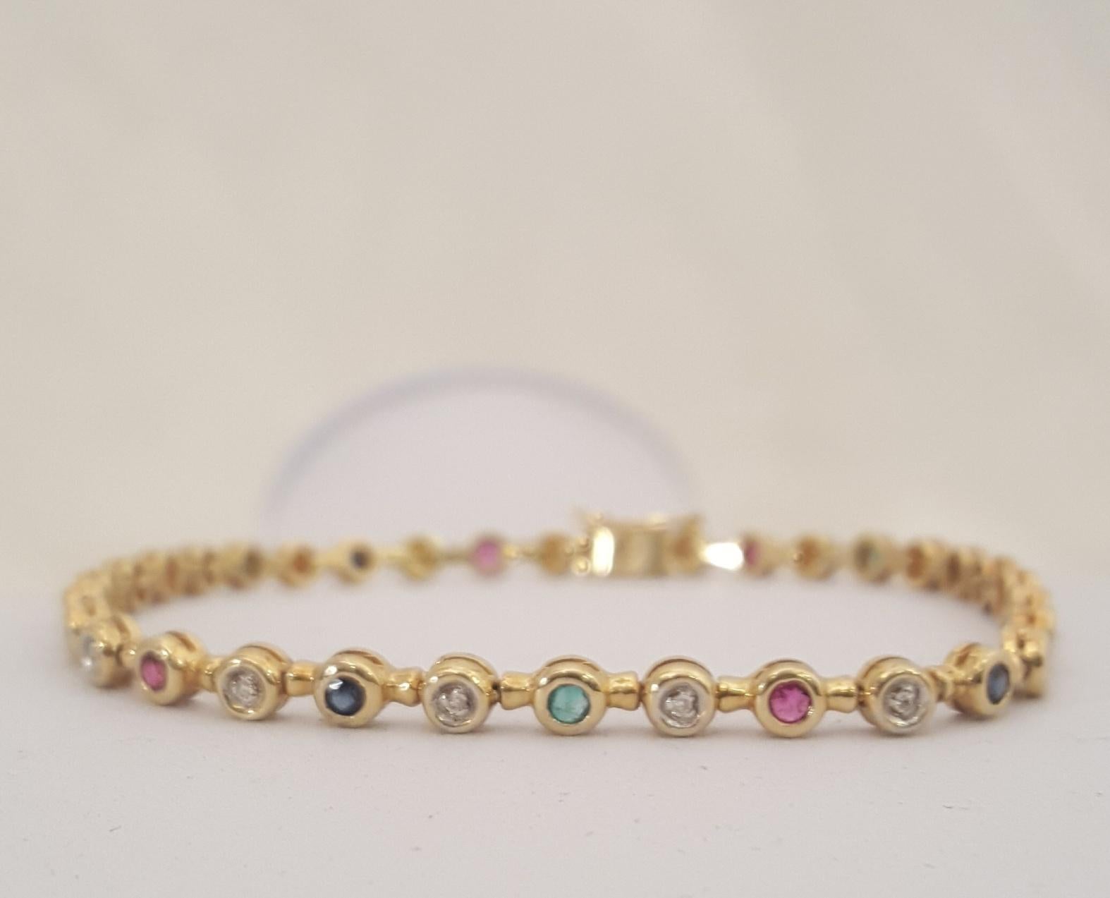 Contemporary 18 Karat Bezel Set Diamonds Emeralds Rubies and Sapphires Inline Tennis Bracelet