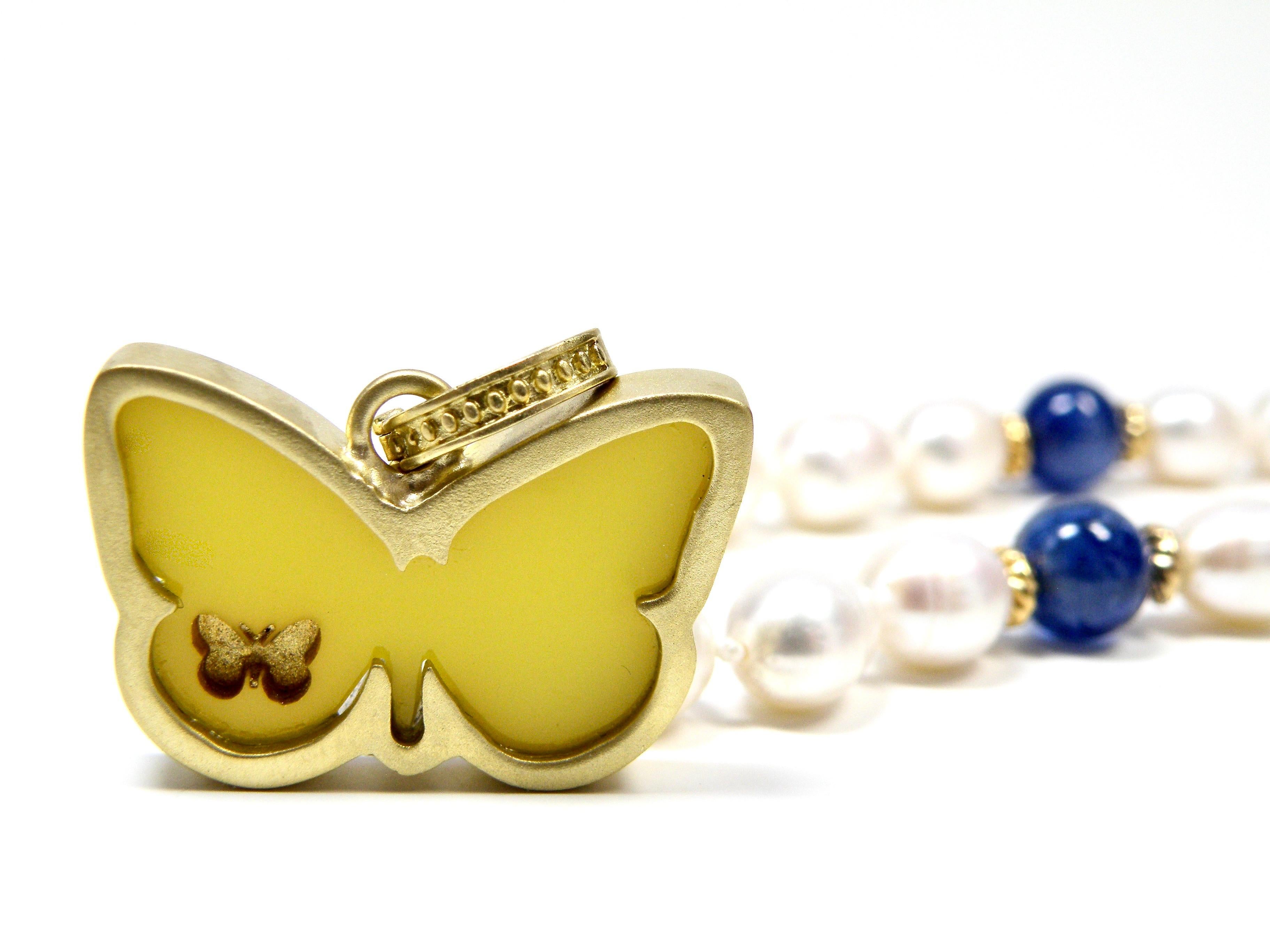 18 karat bezelled butterfly hand carved in yellow agate.