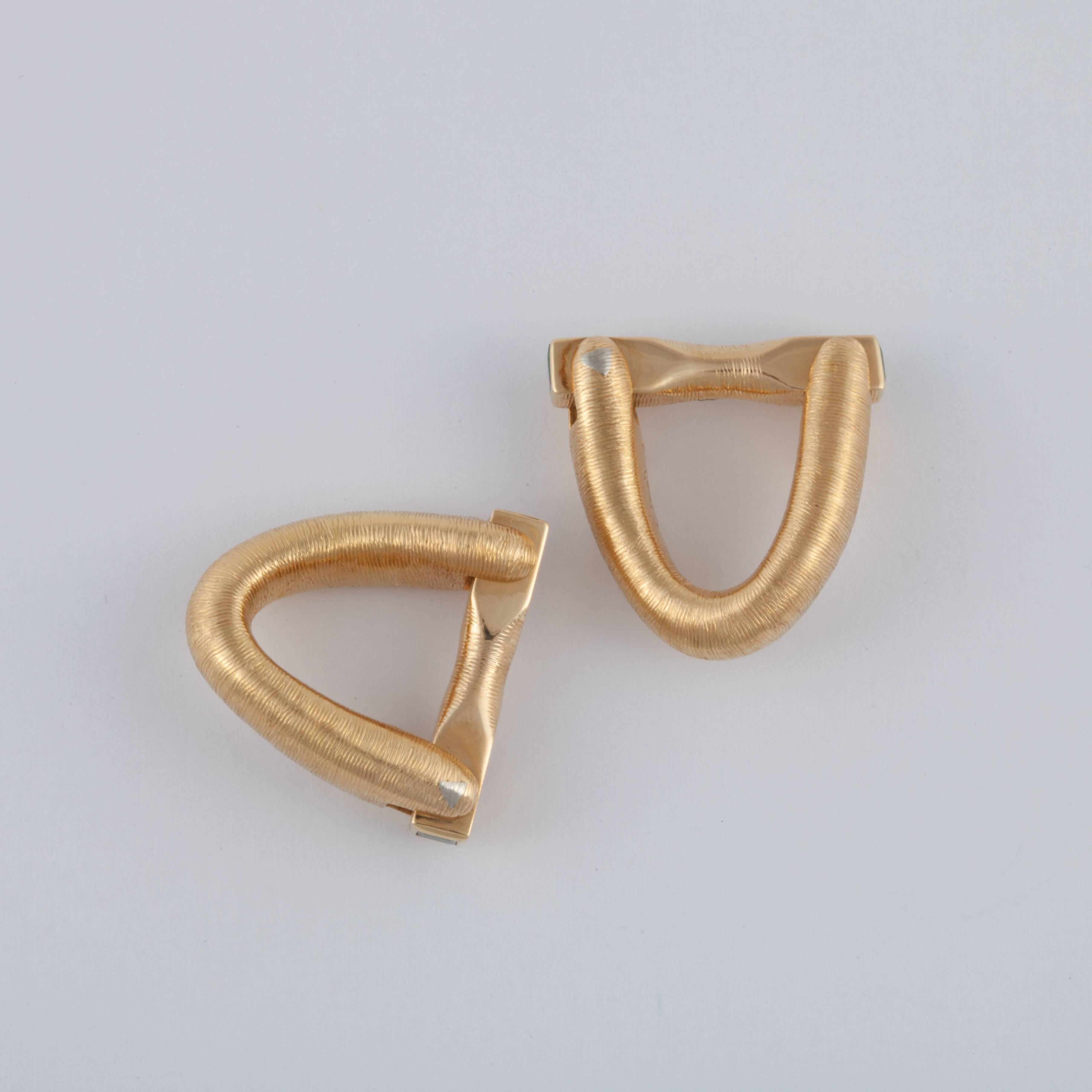 This pair of brushed gold cufflinks is marked 