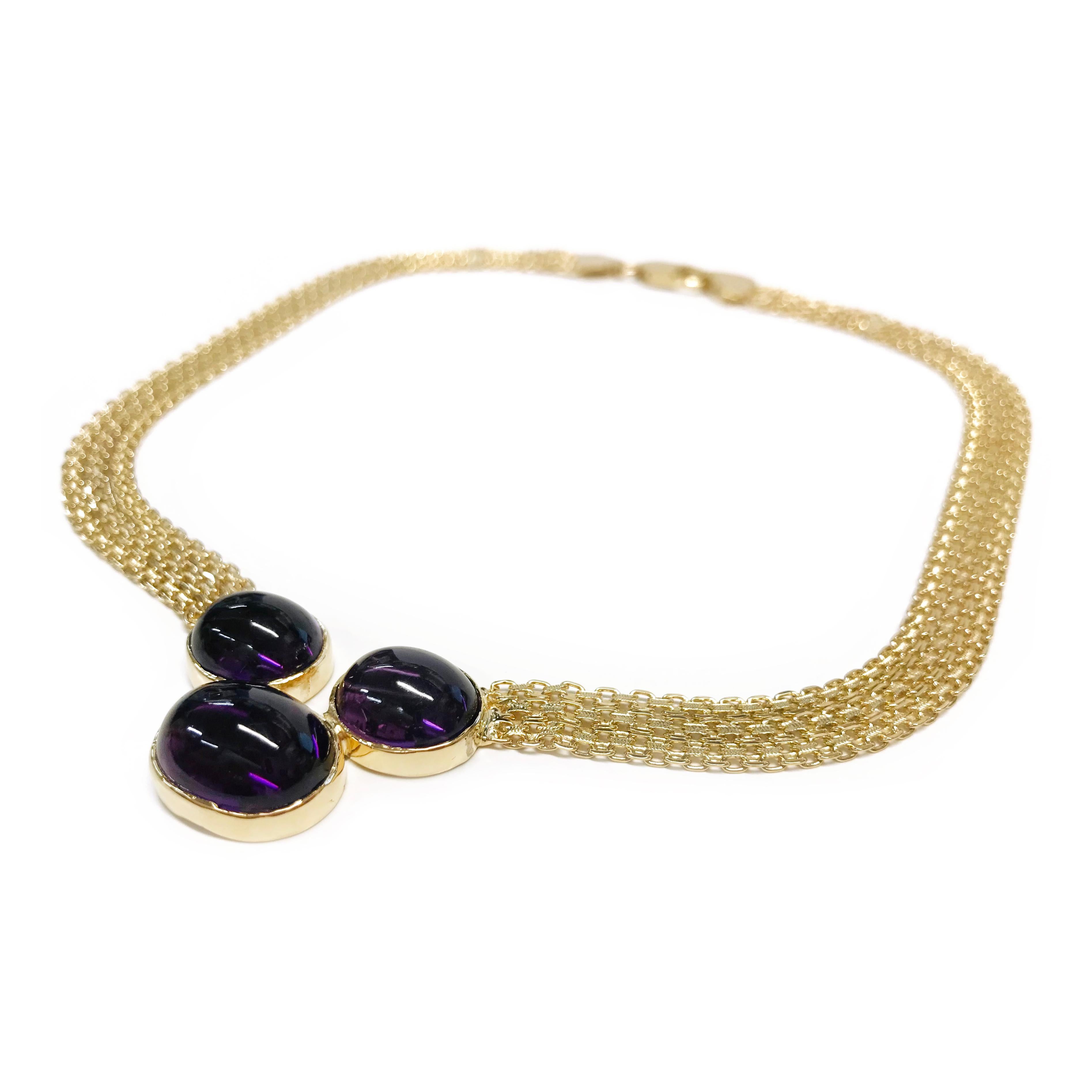 18 Karat Bismark Amethyst Necklace. The flat 9.3mm necklace features three oval bezel-set Amethyst cabochons. The cabochons measure 17.2 x 13.9 x 18.2mm, 14.3 x 13.2 x 18mm, and 14.7 x 13.1 x 17.5mm. Stamped on the clasp of the chain is 62 AR 750,