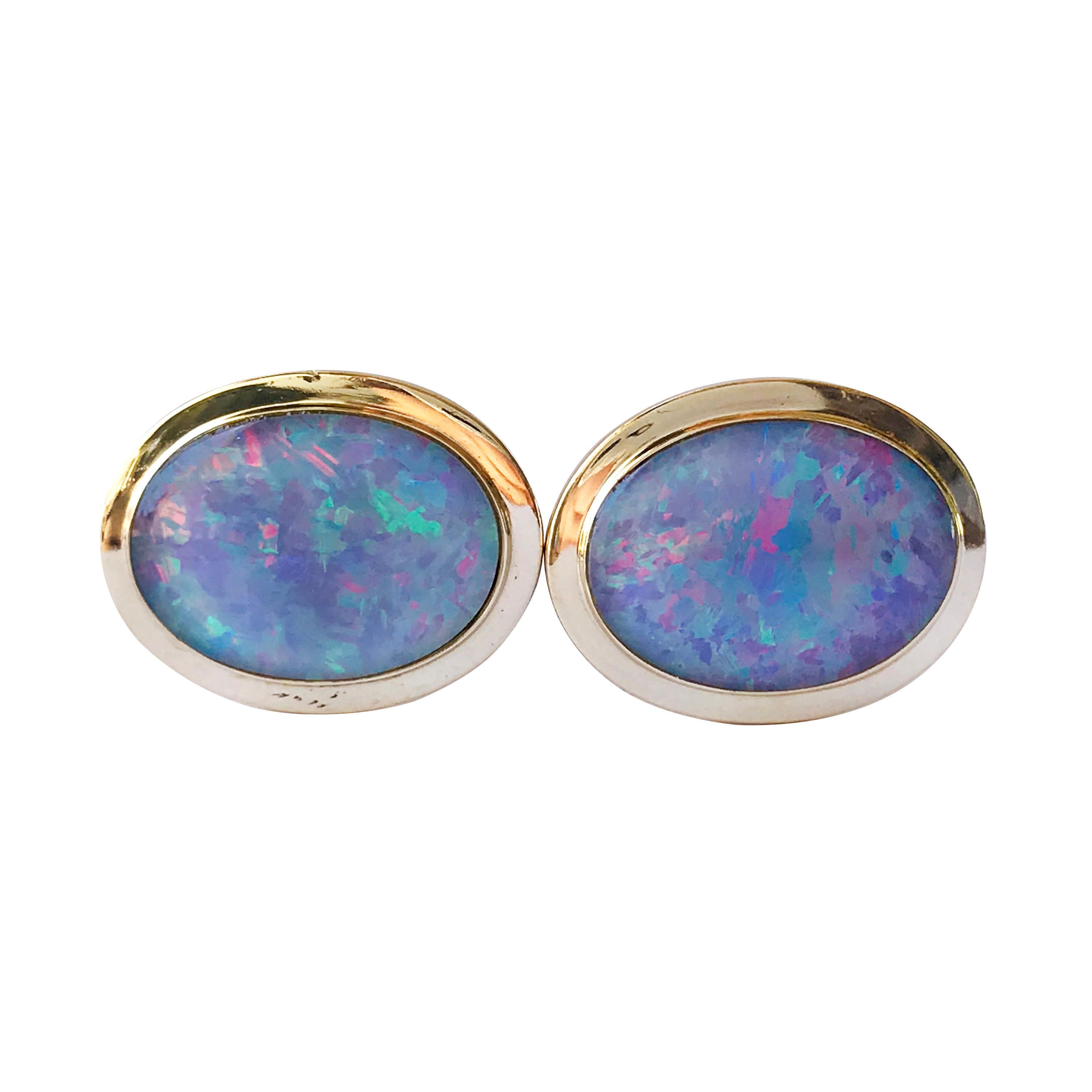 18 Karat Black Opal Oval Cufflinks. The fronts feature bezel-set oval black Opal triplets. Quality is AA: Dark grey to black background, good to medium strong play of color with three major color flashes - blue, green, and red/pink; semi-translucent