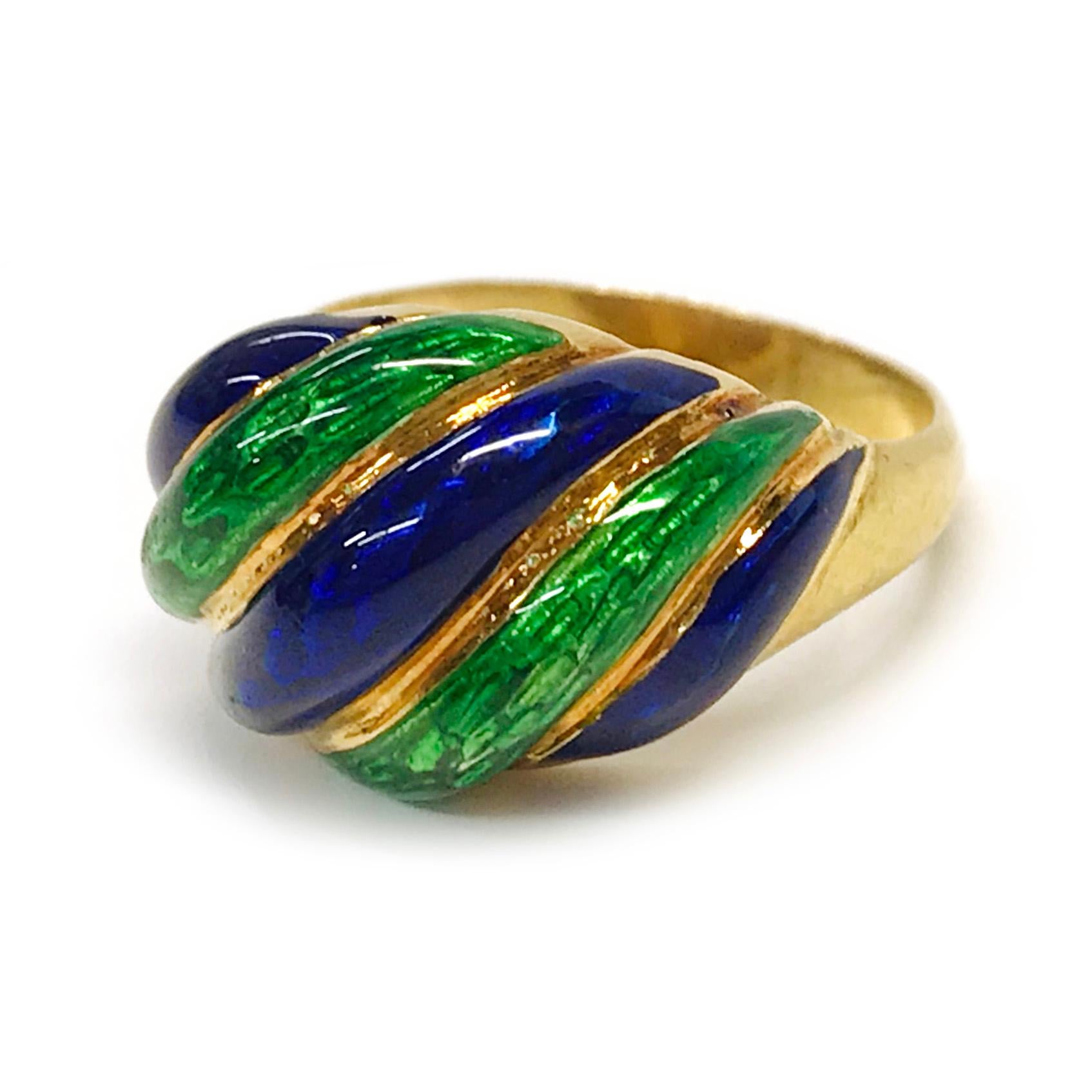 18 Karat Blue Green Enamel Ring. The ring features alternating blue and green enamel swirls on top of the ring and a tapered gold band. The ring is 23mm tall x 18.3mm wide x 11.4mm deep and the ring size is 5 1/4. The total gold weight of the ring