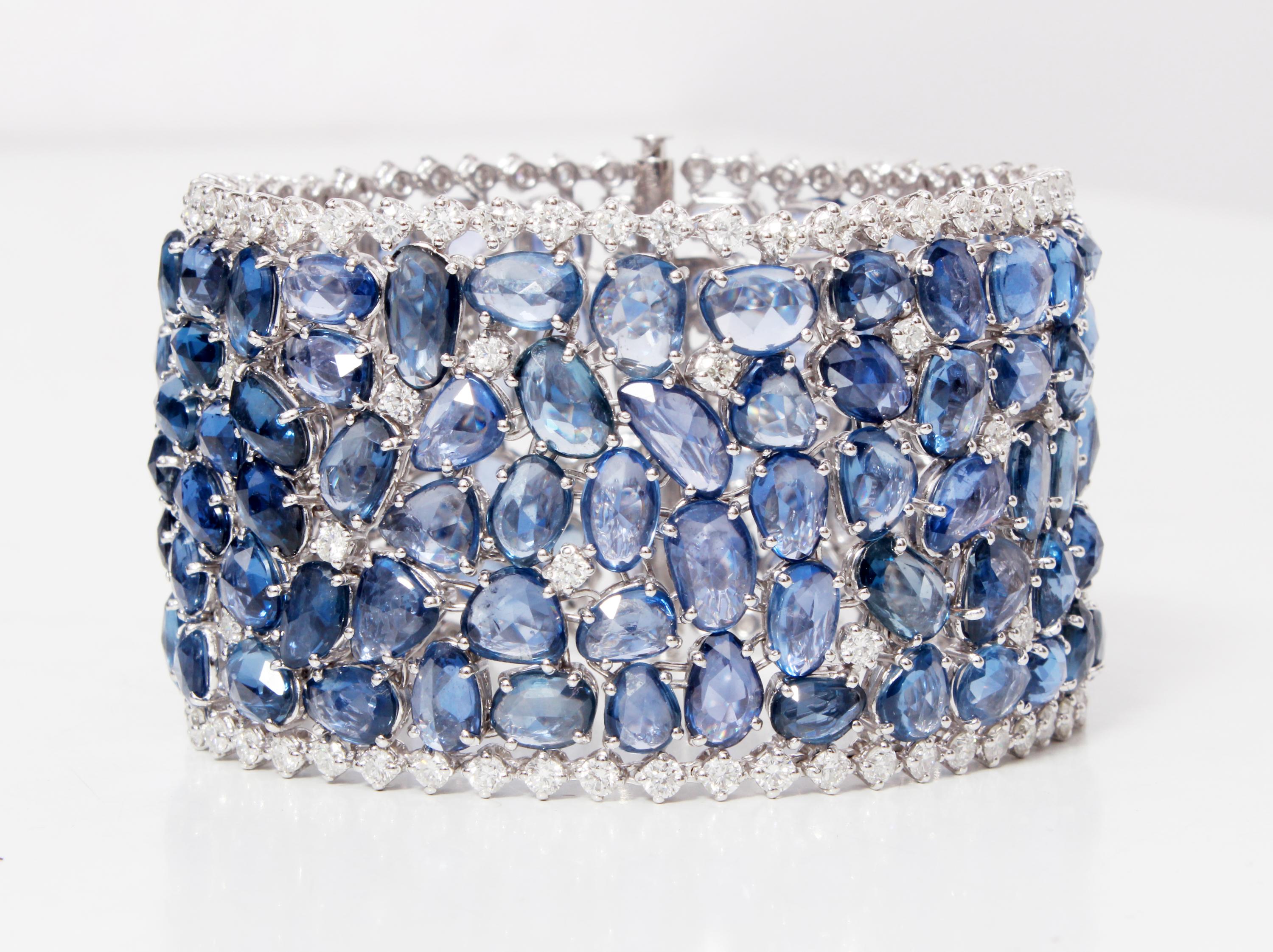 This astonishing bracelet has  139 Rose Cut Blue Sapphires that weighs 124.15 carats. With that, it has 128 Round Cut White Diamonds that weighs 8.60 carats. The bracelet is made in 18K White gold and weighs approximately 78.797 grams.