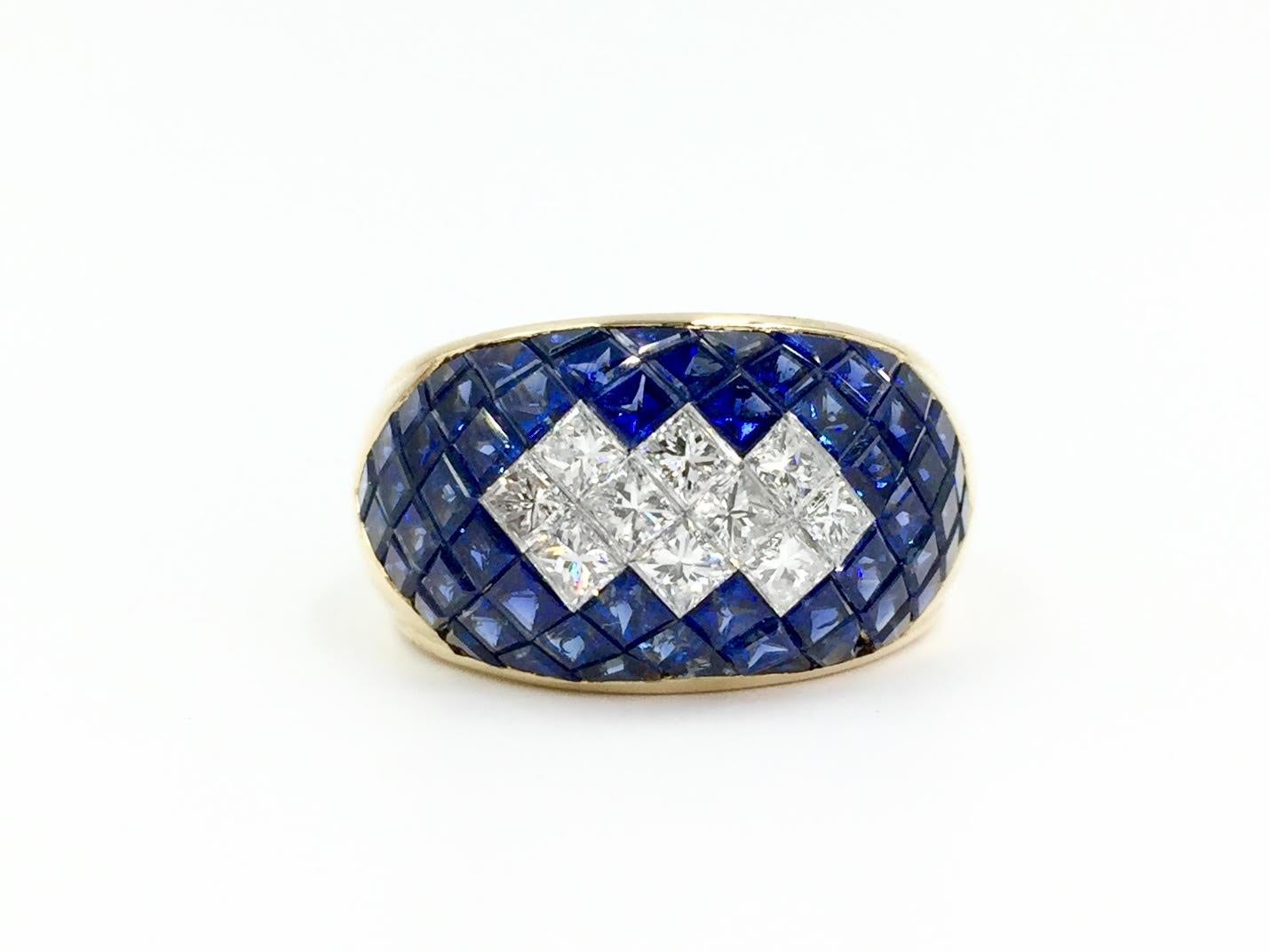 A sleek wide 18 karat slightly domed illusion-set ring featuring 7.93 carats of gorgeous quality sapphires and 1 carat of bright white diamonds. Diamond quality is approximately F color, VVS2 clarity. High quality blue sapphires are semi-transparent