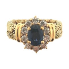 18 Karat Braided Yellow Gold Ring with Brilliant Cut Diamonds and Oval Sapphire