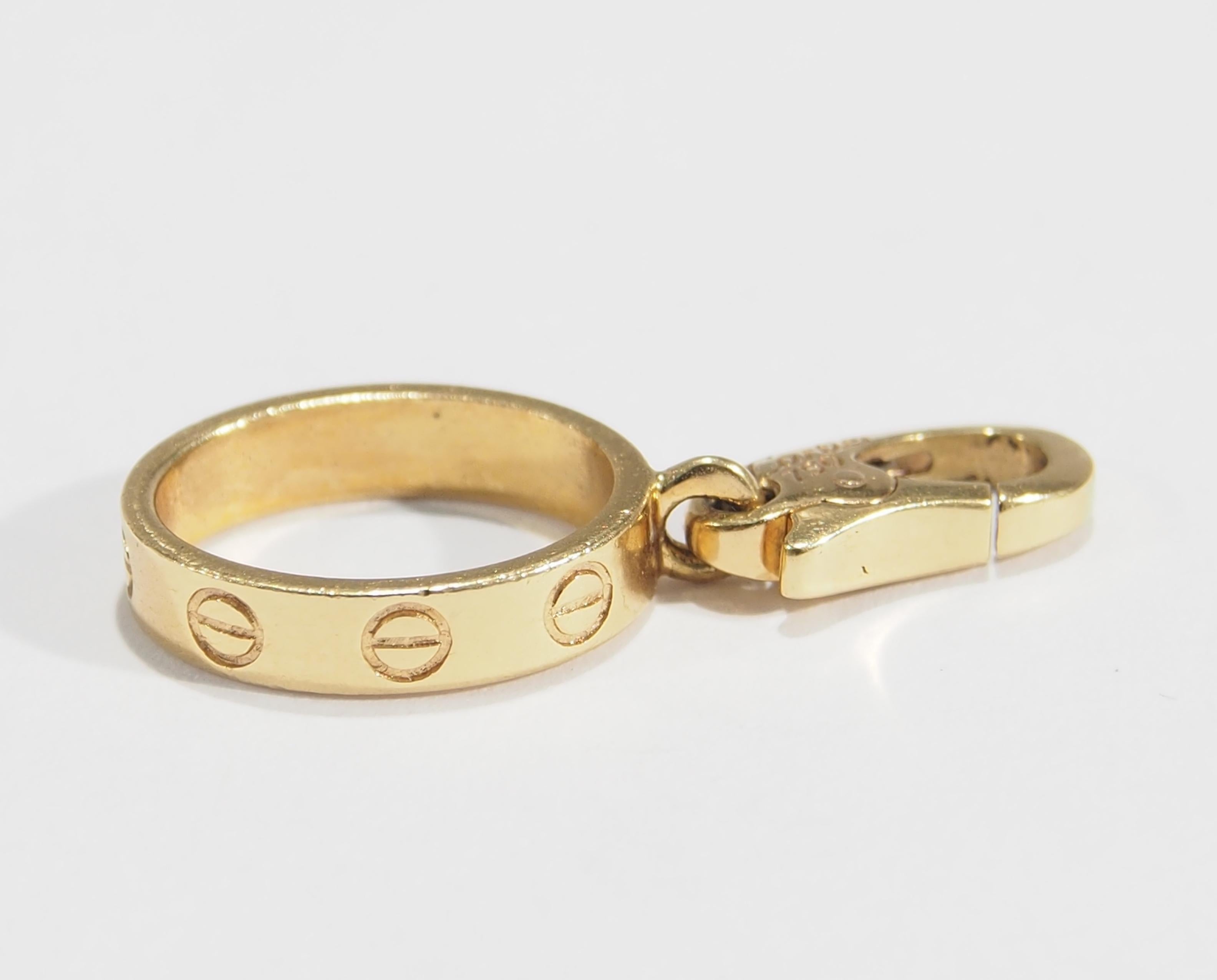 From the iconic designer Cartier, is their delightful 18K Yellow Gold Love Ring Charm created for their charm collection to enhance either their bracelets or necklaces. Designed with precious detail the Charm measures 1 inch in length and 3/8 inch
