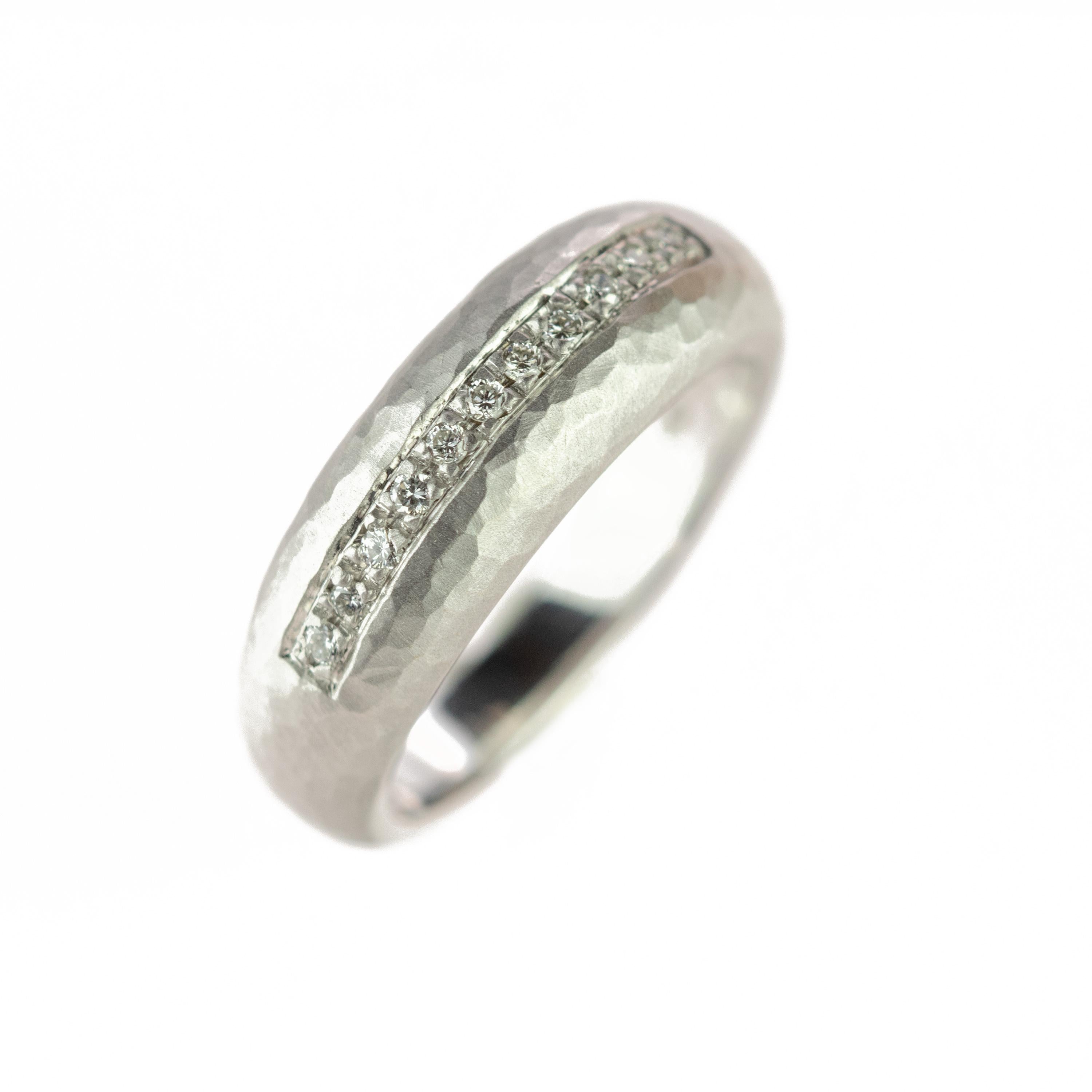 Stunning and marvelous diamond ring embellished by 18 karat carved white gold. Over 11 diamonds, 0.11 carat, create a line of gems crafted carefully to be as delicate as the band design. 
 
Legends tell that the first band rings were created at