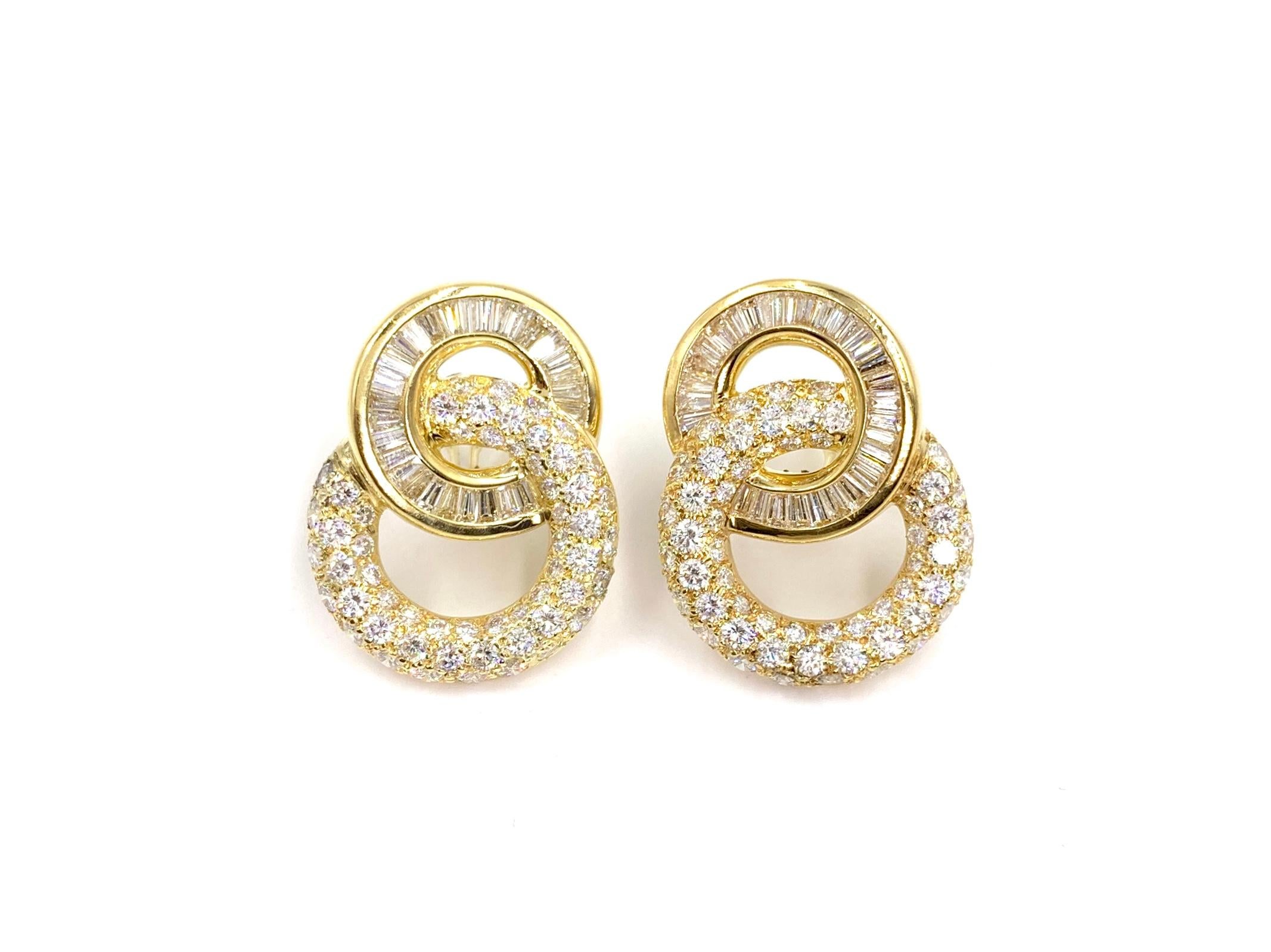 Incredibly well made with a beautiful timeless design, these 18 karat yellow gold earrings feature approximately 9 carats of round brilliant and baguette cut diamonds. Diamonds are of high quality at approximately F-G color, VS1-VS2 clarity. Round