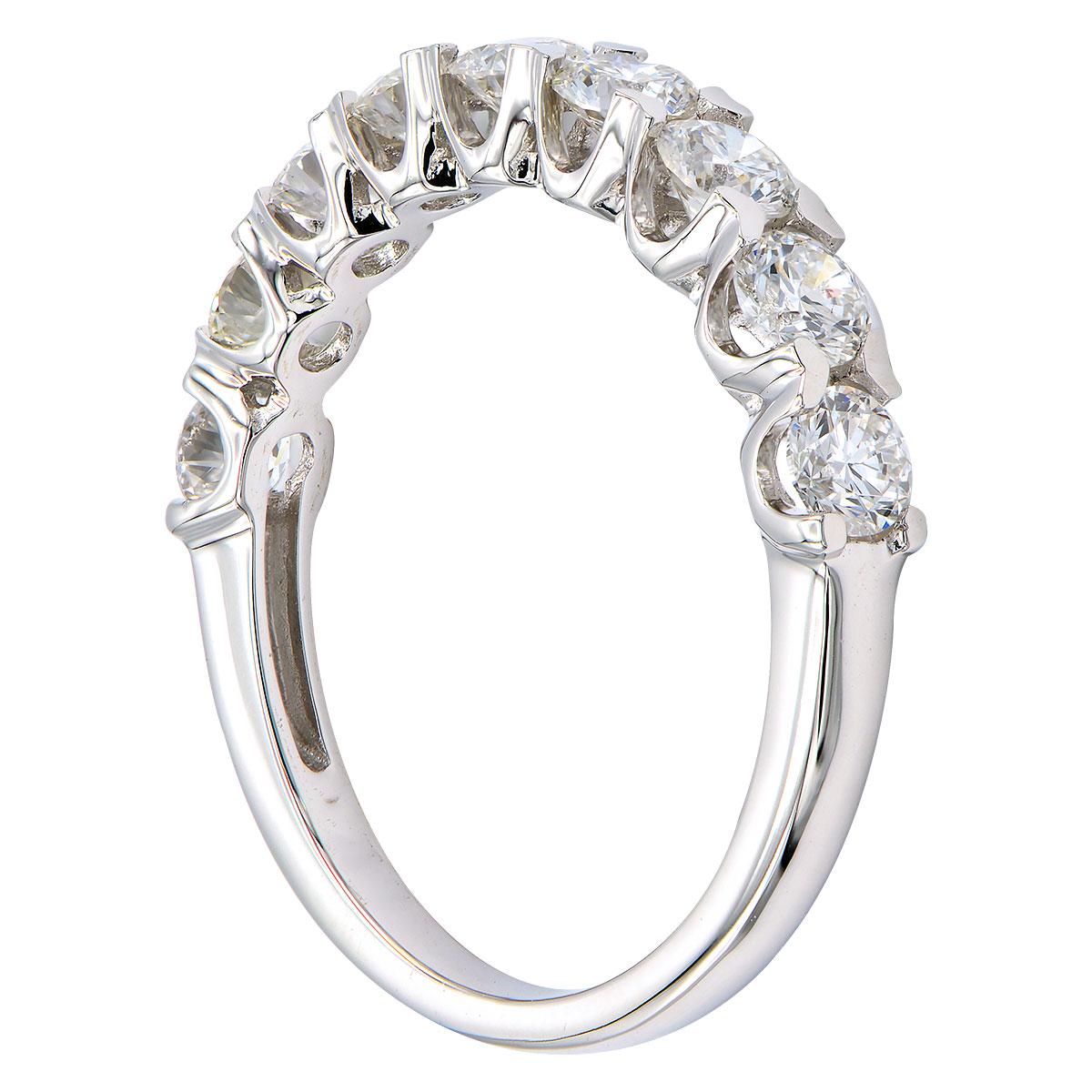 This classic stunning band has 9 round VS2, G color diamonds totaling 1.09 carats that go halfway around the band. They are secured with gorgeous prongs that add design detail to the sides of the ring. This ring is made from 2.3 grams of 18 karat