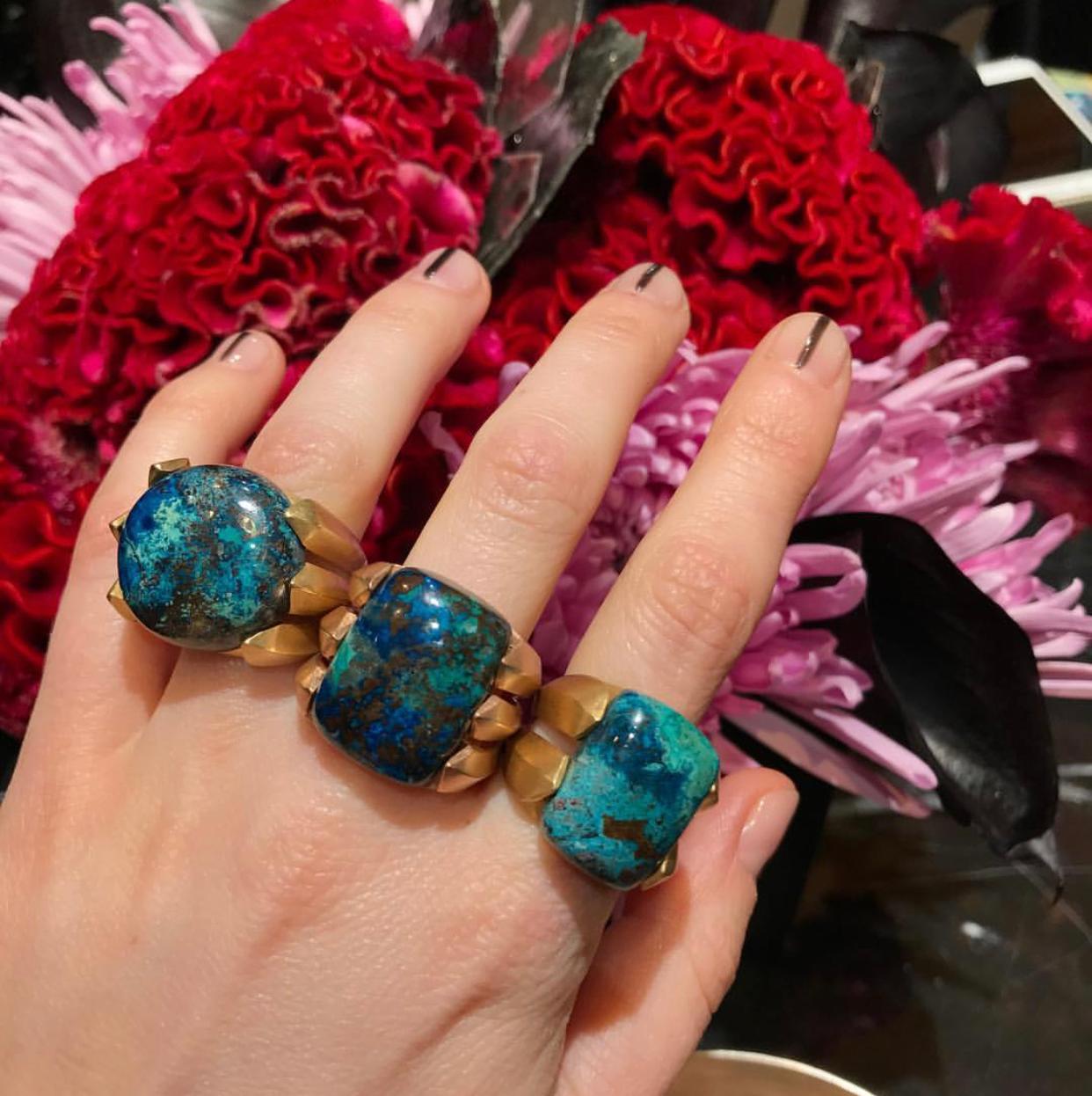 18 Karat Custom Cut Chrysocolla Cocktail Ring features two solid gold ridges set on either side of the large rectangular chrysocolla and set on a rounded solid gold band.
18k Yellow Gold, Chrysocolla
From Karma El Khalil's Rock Hall Collection 
