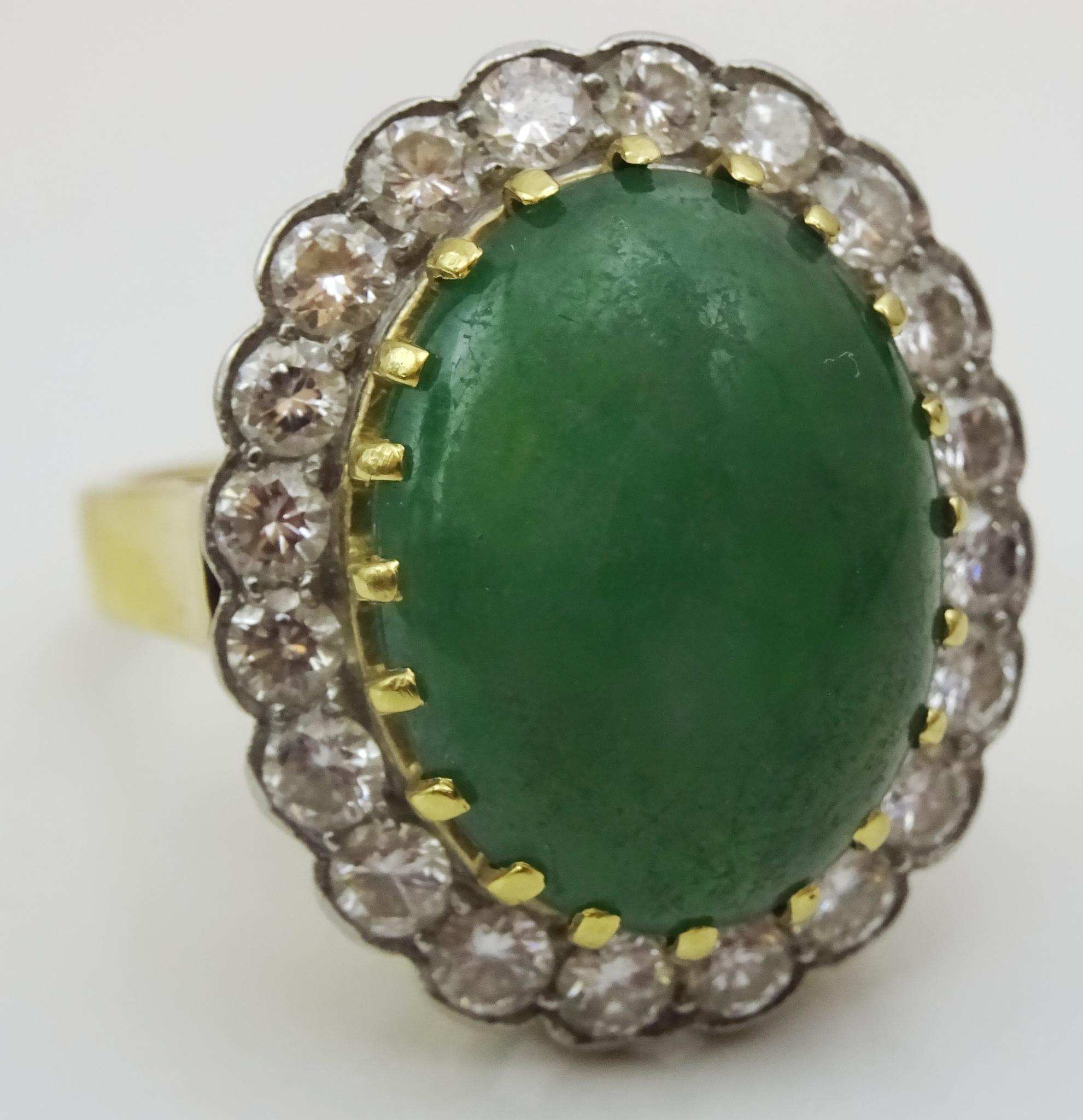 An exquisite high quality Ring , bought from a private client.
According to the individual i bough this ring was bought in the 1960's.
Composed of a central Dark Green Jade measuring 12 x 16 mm oval that is surrounded by 20 3.2 mm Diamonds , VS
