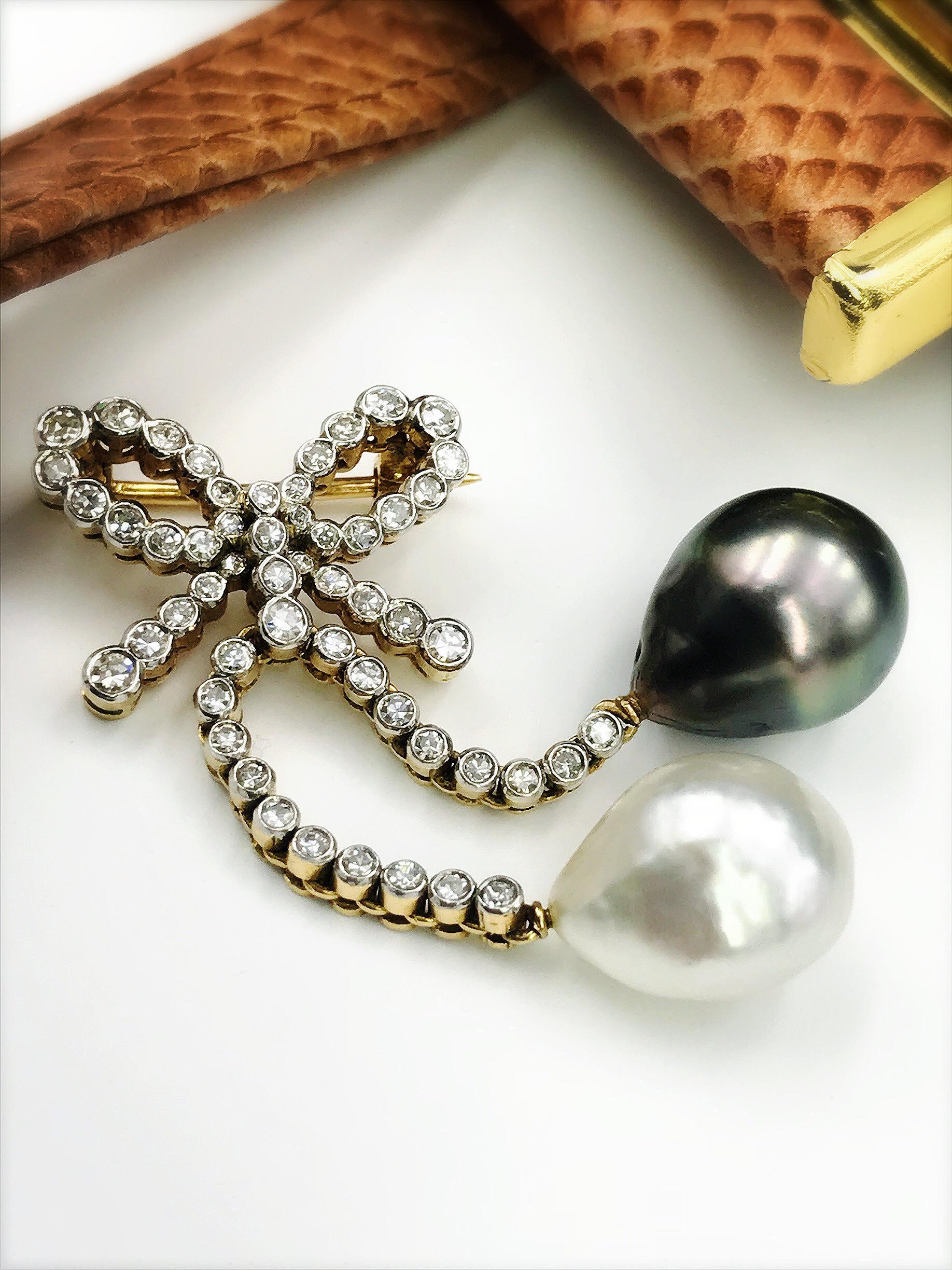 A diamond and cultured pearl brooch. The single-cut diamond bow, suspending two grey and white cultured pearl drops on similarly-cut diamond articulated lines. Estimated total diamond weight 0.60ct. Portuguese marks. Length 5.3cms. Weight 12.4gms.