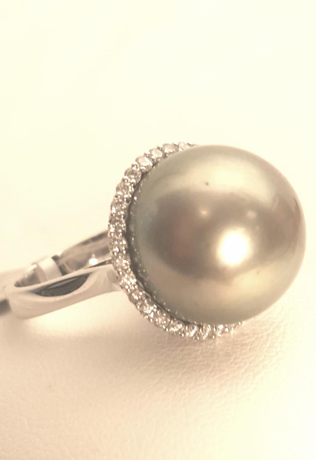 Brand New!  A fabulous statement ring fabricated in 18 karat white gold!  An impressive Tahitian South Sea pearl in a lovely shade of gray measuring 15-16mm is the focal point.  A row of micro pave white diamonds frames the pearl.  Diamond weight