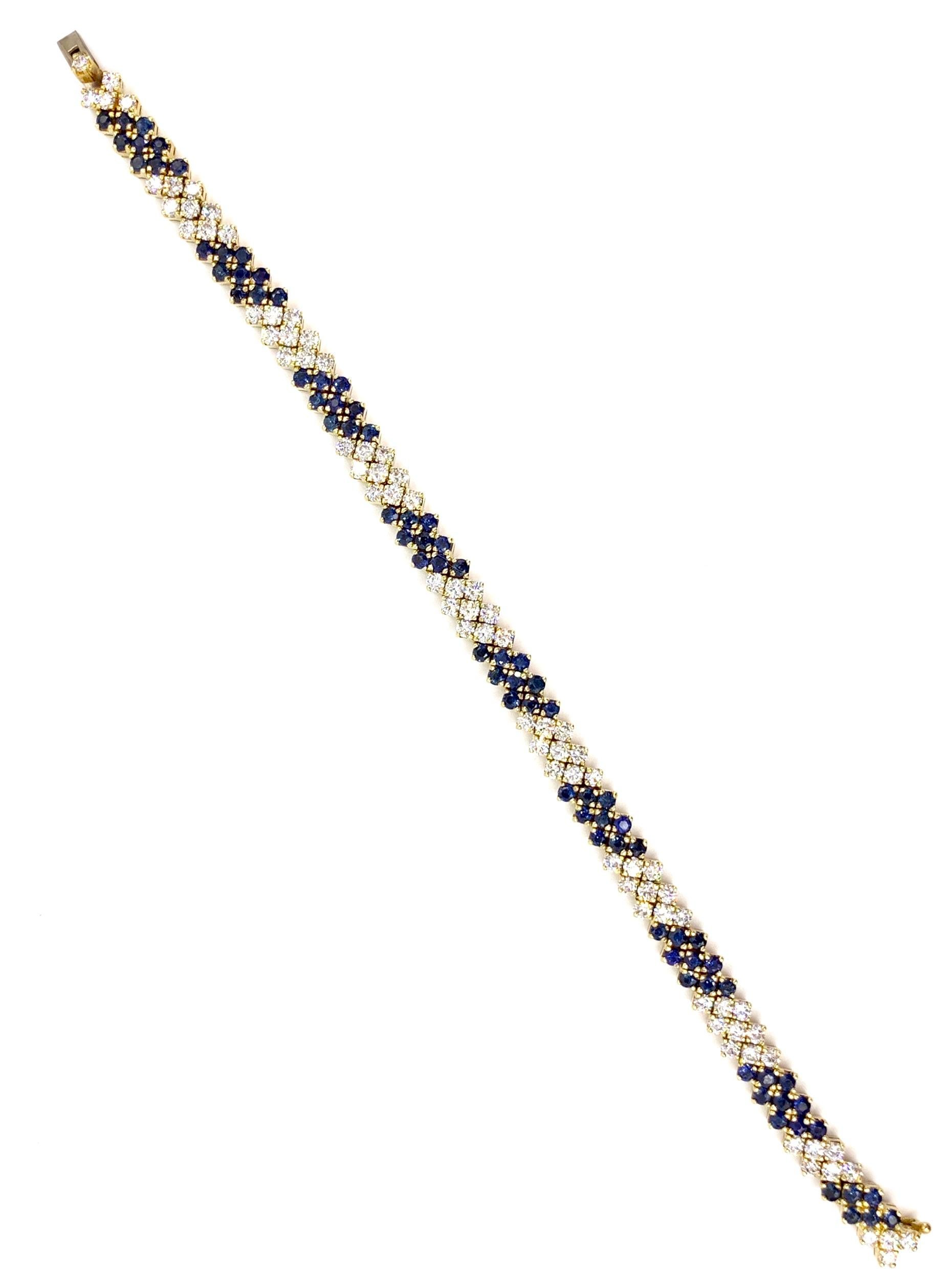 An elegant yet wearable 18 karat yellow gold tennis bracelet featuring three rows of alternating sections of high quality round brilliant white diamonds and blue sapphires. 75 White diamonds have an approximate total weight of 3.75 carats. 78 Blue