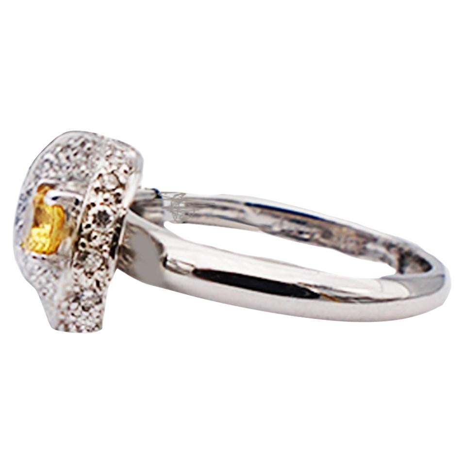 Quality, Sweet ring!
Center stone is a oval shaped yellow sapphire set in a shield style design. The convex top of ring is encrusted in diamonds and on it's edges. The total diamond weight of the ring is estimated at .40 carat. Quality of the