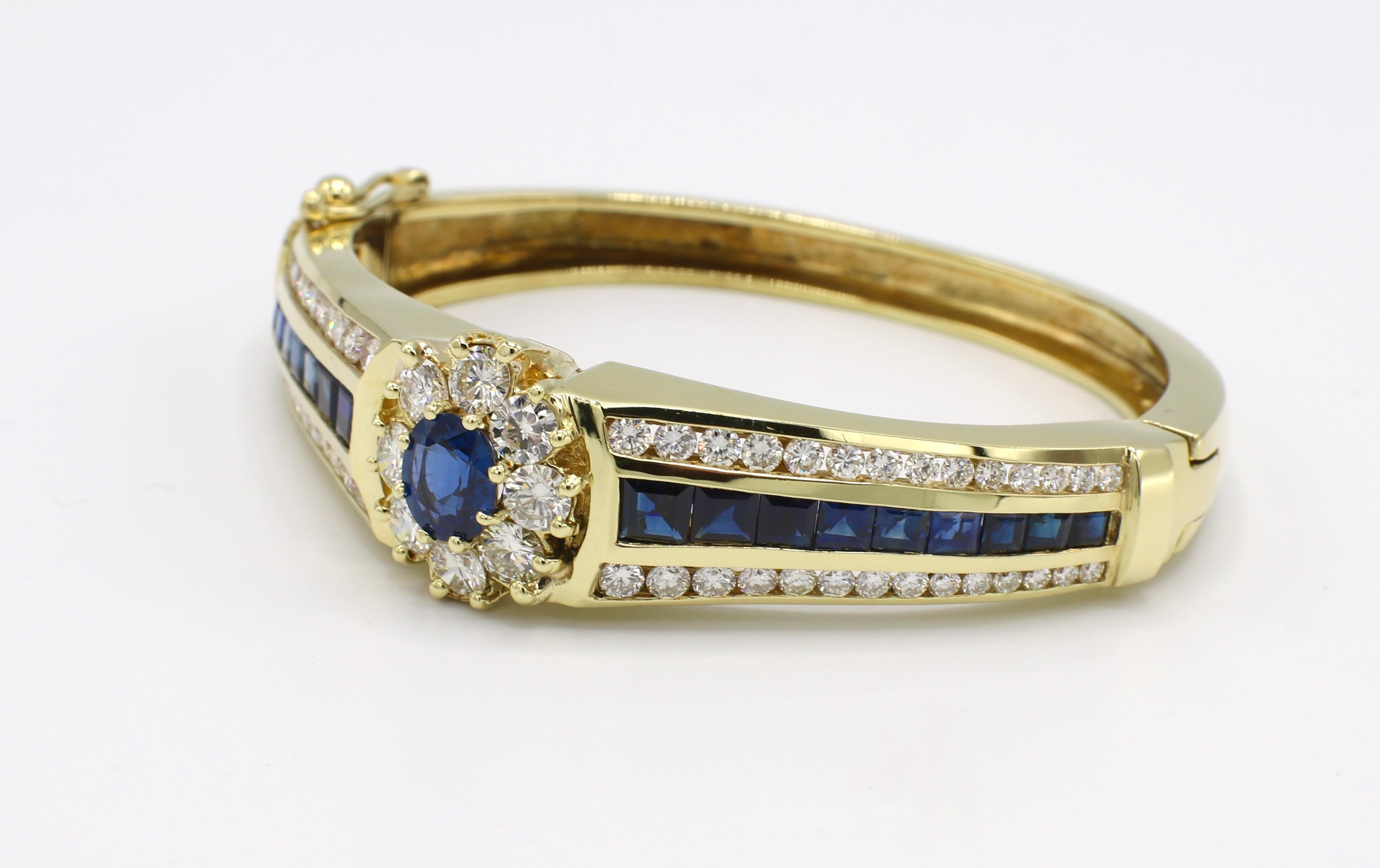 GIA Certified 18 Karat 6.5 Carat Diamond & Blue Sapphire Hinged Bangle Bracelet 
GIA report number: 2215398956 (please note original GIA report pictured for details) 
Metal: 18k yellow gold
Weight: 61.45 grams
Diamonds: Approx. 6.5 CTW G VS round
