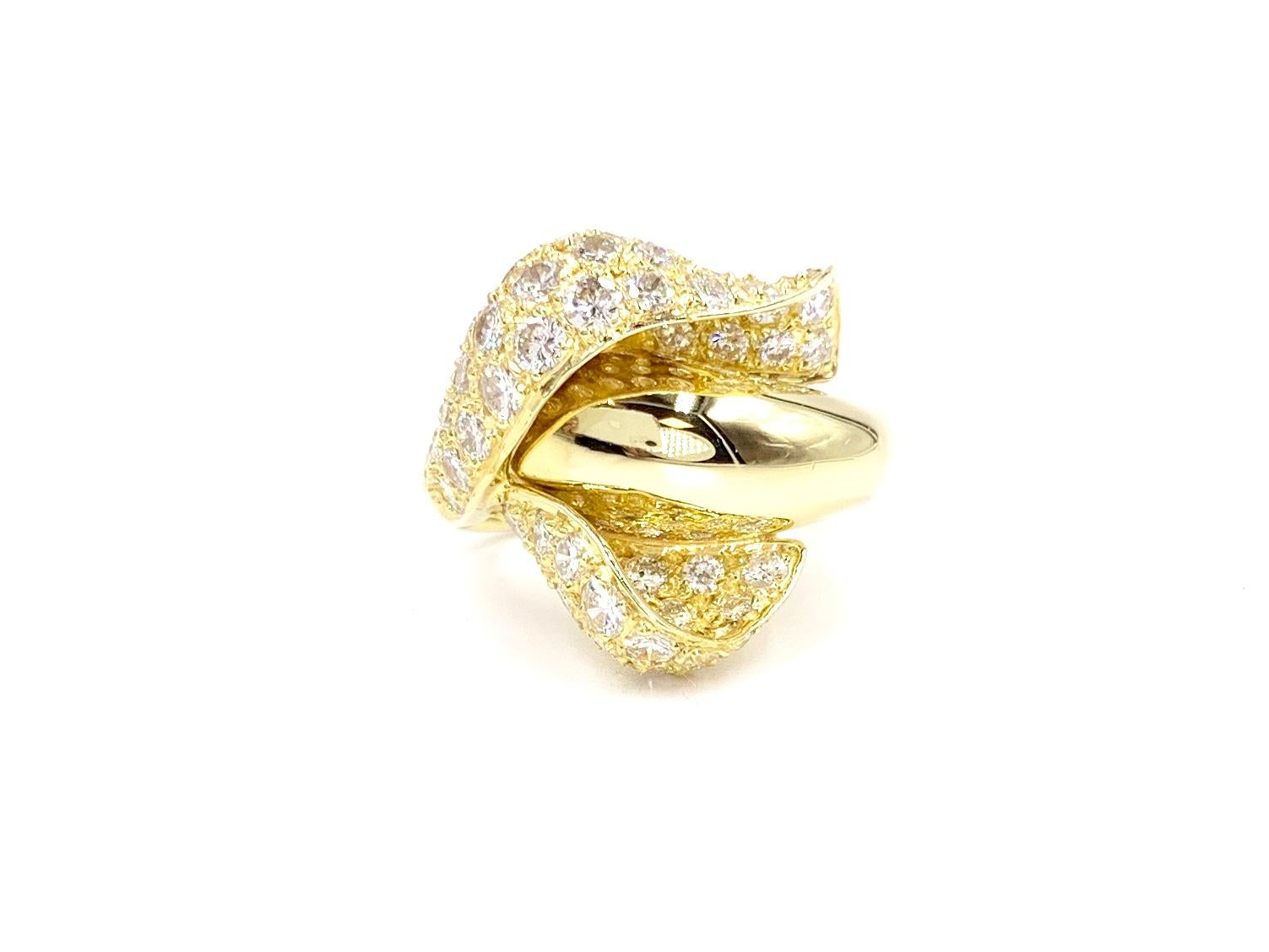 An exquisite Calla Lily flower ring created by expert jeweler, Jose Hess. This 18 karat yellow gold ring is feminine and beautiful with pavé white round brilliant diamonds on the petals with a smooth, polished gold shank as the stem. Ring consists