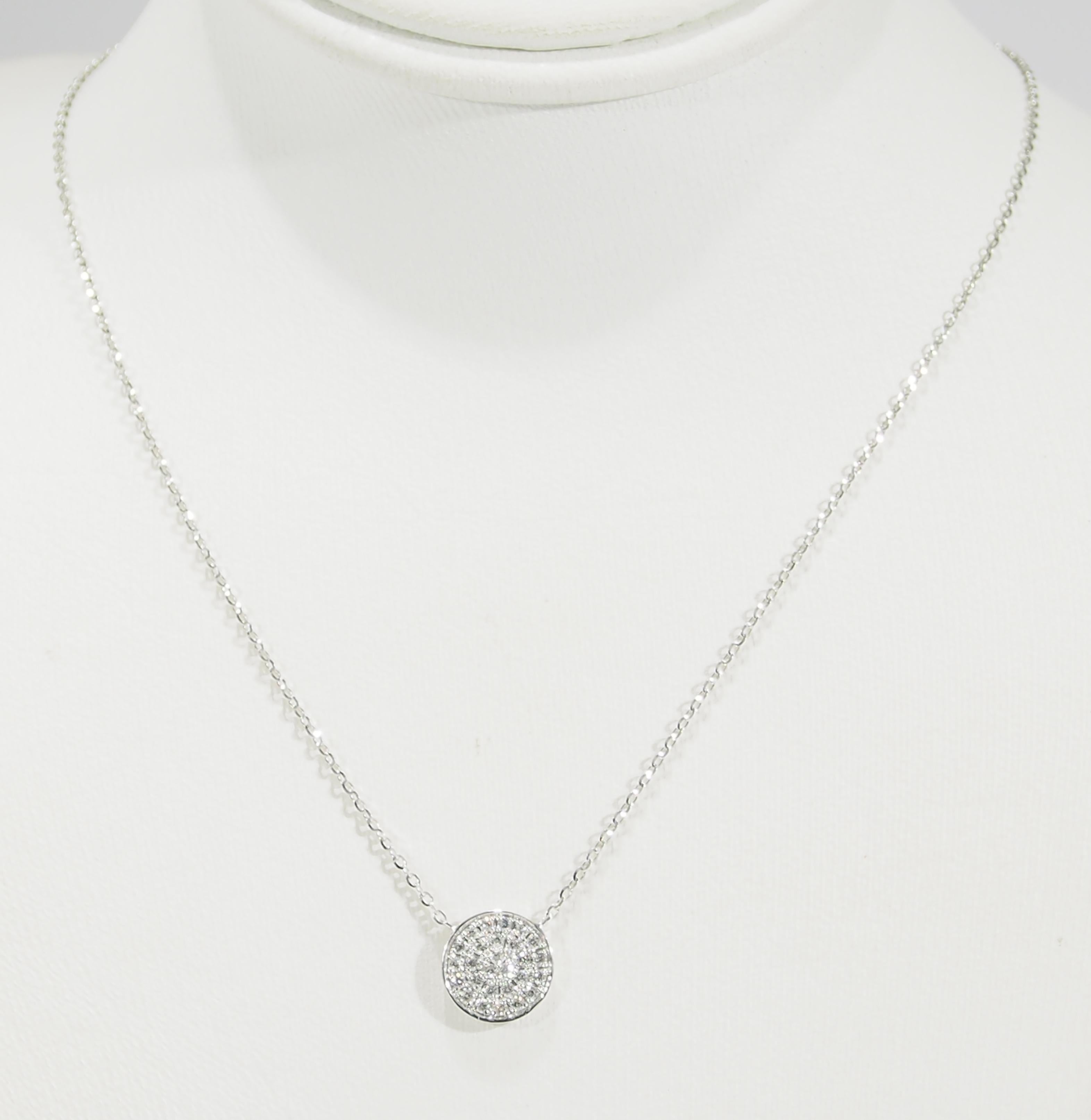 This is a delightful 18K White Gold Necklace highlighted by a sparkling Diamond Disc. There are (27) Round Brilliant Cut Diamonds, approximately 0.18ctw, G-H in Color, VS-SI in Clarity set in a 3/8 inch diameter Disc. A charming Necklace to be worn