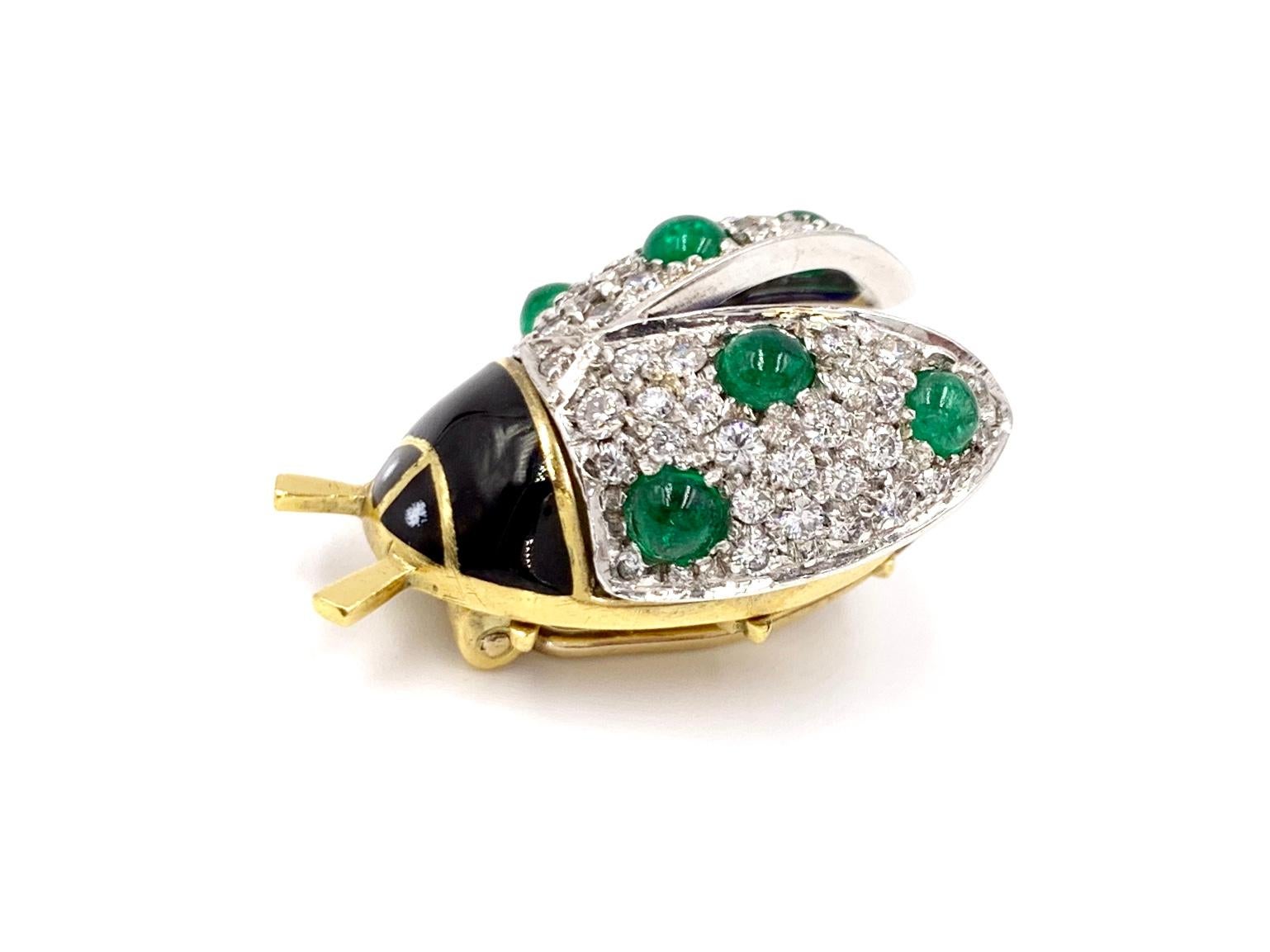 Adorable 18 karat yellow and white gold beetle brooch featuring 53 round diamonds, perfectly pavé set at .88 carats total weight. Diamond quality is approximately G color, SI1 clarity. 6 well saturated cabochon emeralds have a total weight of 1.10