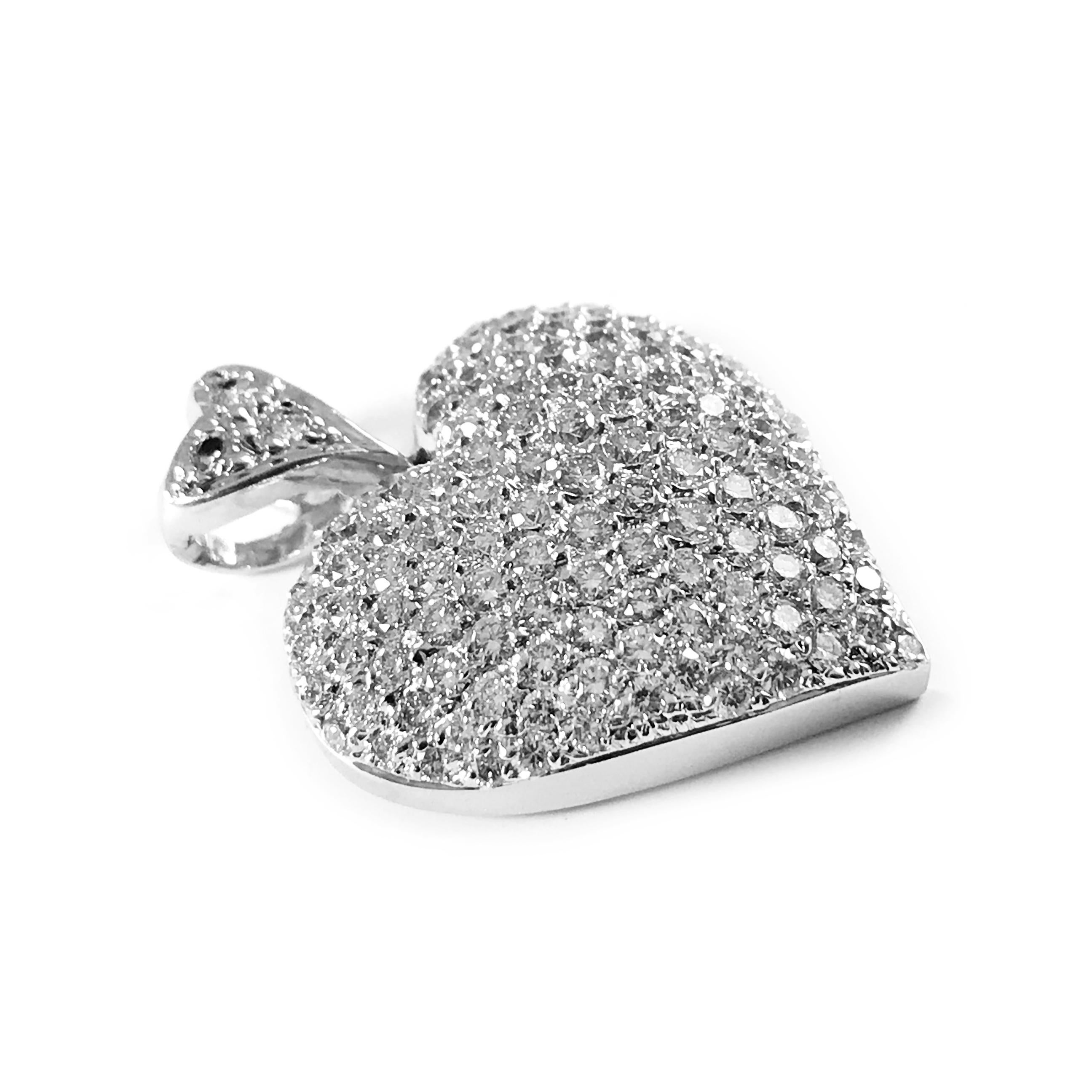 18 Karat white gold pavé set Diamond Heart Pendant. The top and bell of this sparkly pendant are adorned with forty-two (42) 1.3mm and eighty (80) 1.7mm round brilliant-cut pavé set diamonds. A total of 2.02ctw round diamonds are set on the heart