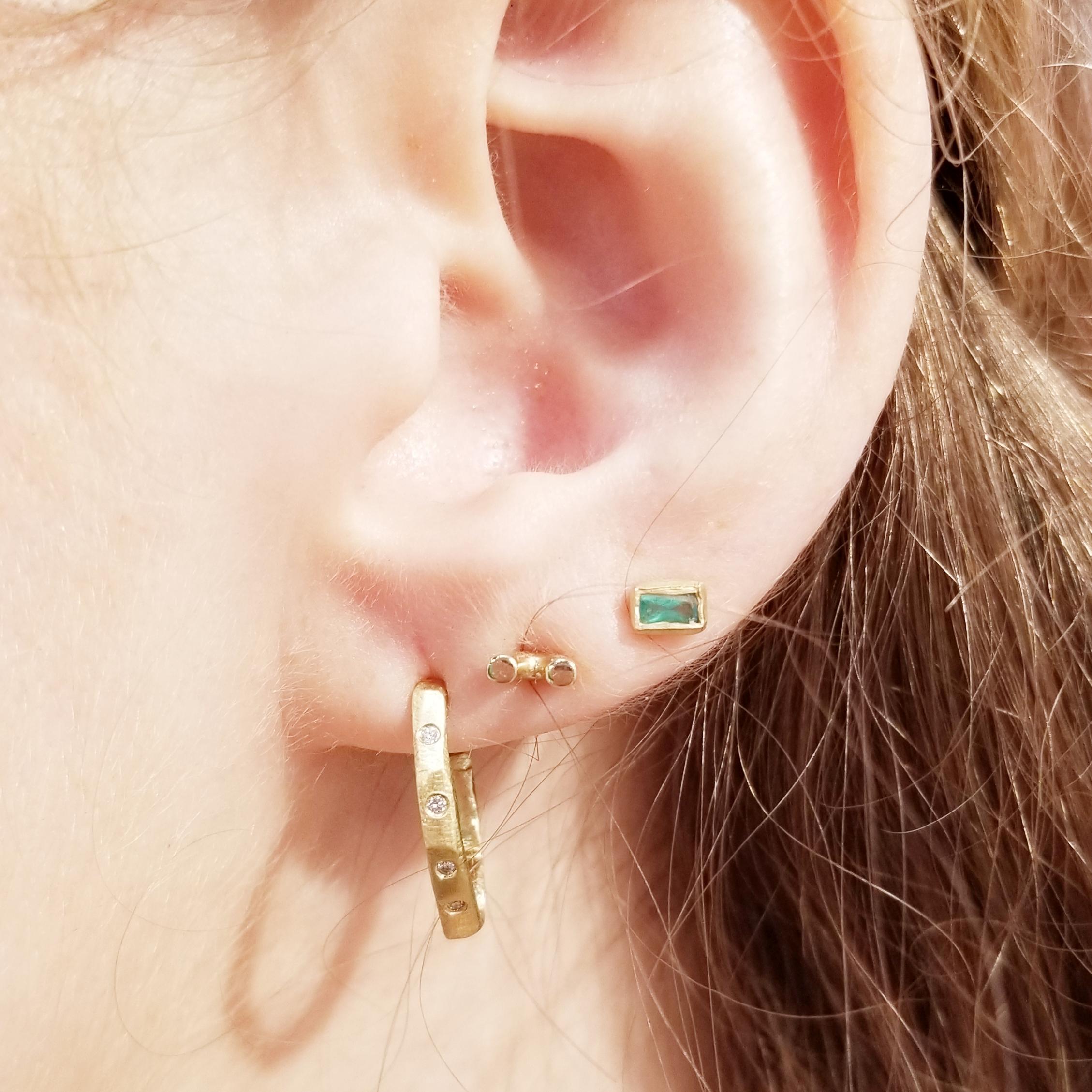 18KT gold diamond hoop earring handcarved by NYC jeweler Page Sargisson.  Perfect hoops that are both classic and modern at the same time.

Measures just under an inch.  Can be made without diamonds.  Contact seller if interested.