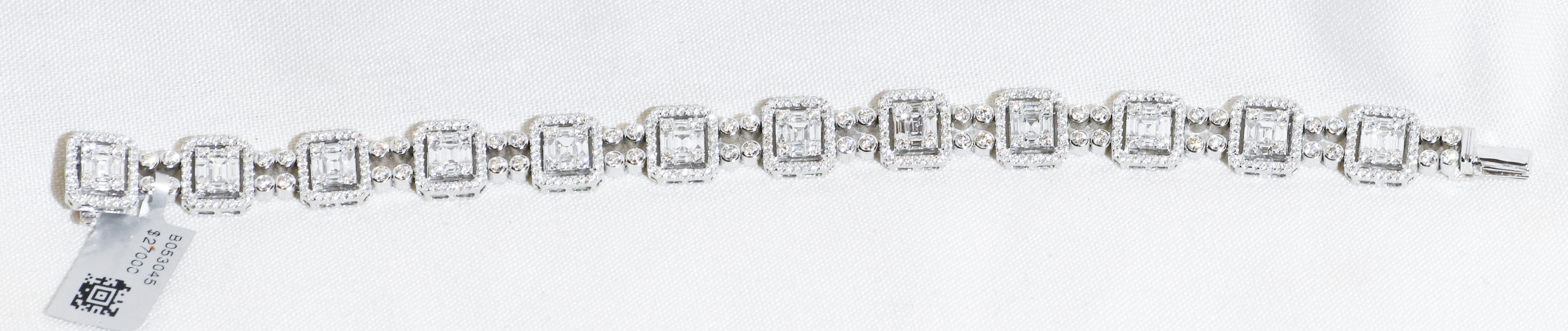 Meticulously crafted in 18 karat white gold, this stunning bracelet is genius of design.  Eleven stations appear to contain a large emerald cut diamond in the center.  Closer inspection reveals each station containing at the center a Princess cut