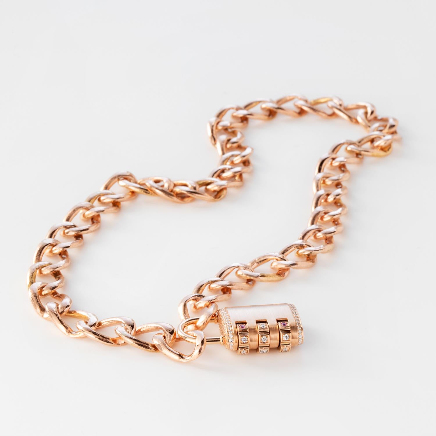 This Padlock Pendant Necklace features a solid 18k Rose Gold removable padlock pendant with pave White Diamonds throughout and white diamonds and pink sapphires on the dial, and a custom code that locks and unlocks the pendant onto the solid 14k