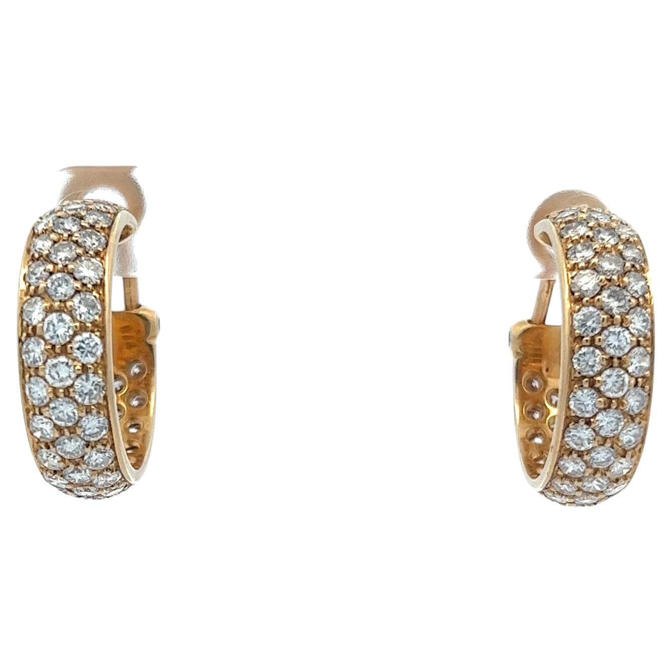 Introducing our exquisite 18 karat yellow gold hoop huggie earrings, meticulously adorned with a stunning array of diamonds. This pair of earrings epitomizes elegance and luxury, featuring a delicate pave setting that showcases the brilliance of 108