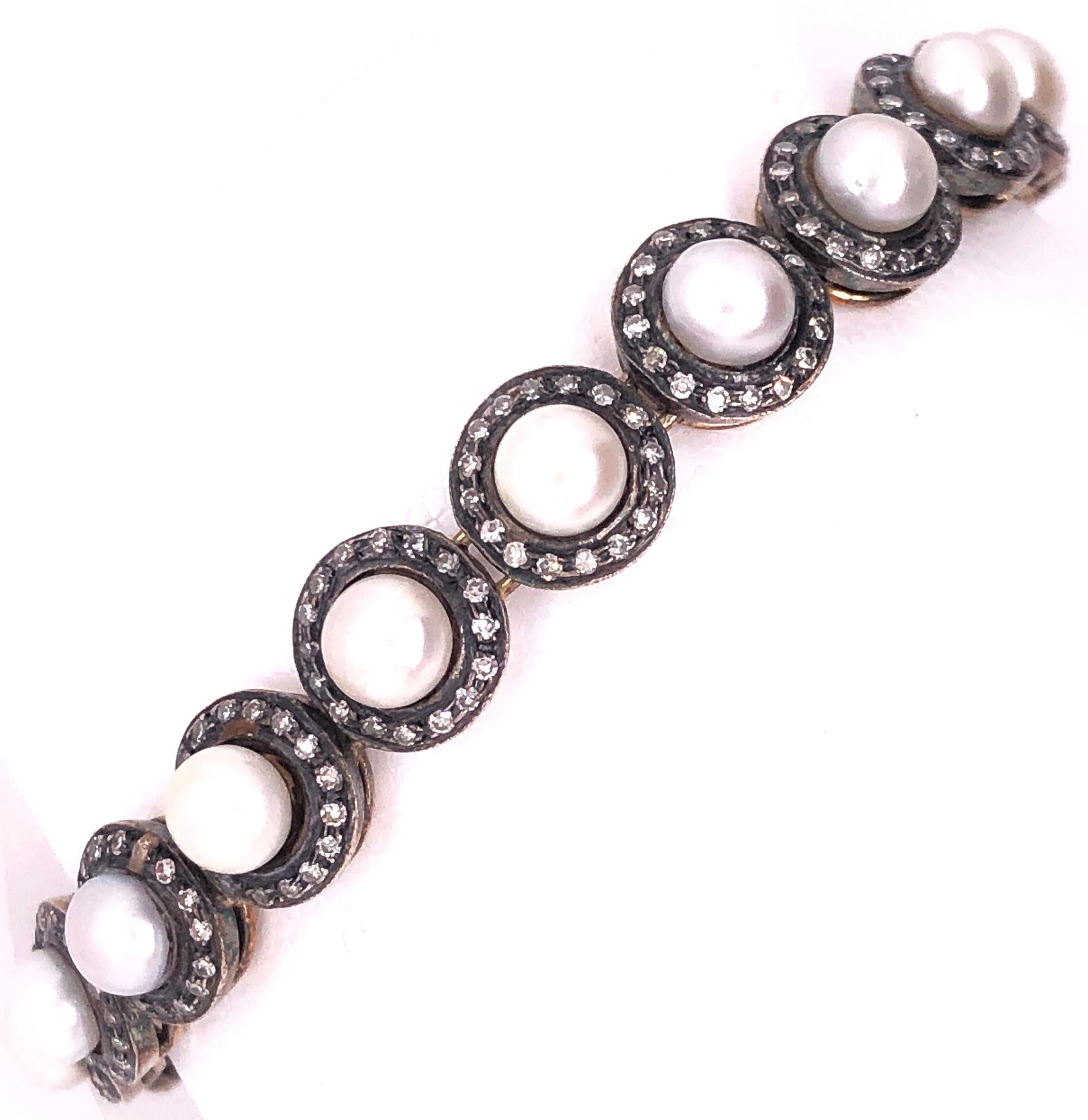 18 Karat Diamond & Pearl 7 Inch Bracelet Fine Estate Jewelry Designed as an articulated line of 19, 5.60mm to 6.0mm pearls flanked by 17, .75 diamonds for a total diamond weight of 2.4 Carats. 24.3 grams total weight.
Provenance:
A NYC Socialite