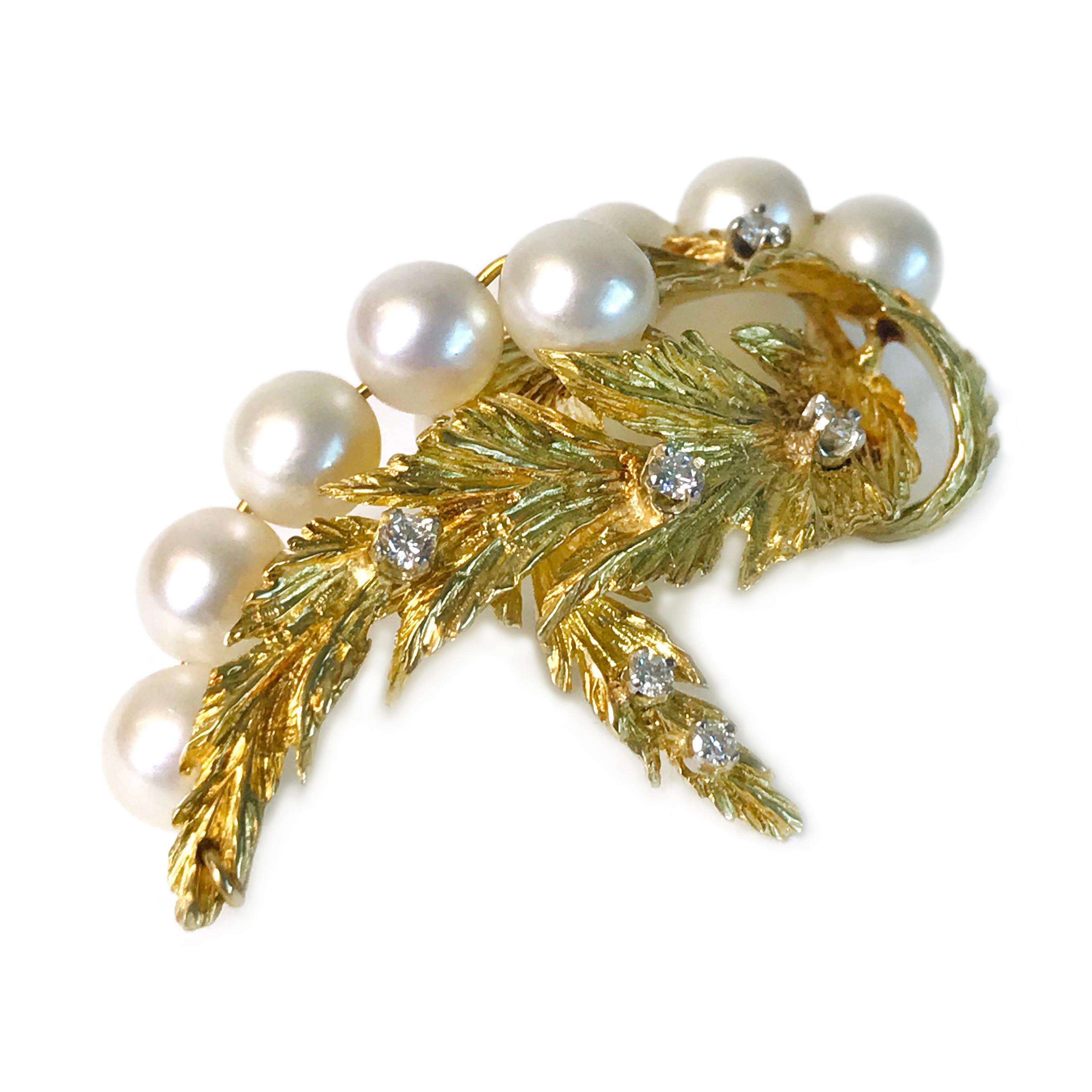 18 Karat Diamond Pearl Leaves Brooch. This brooch features ten (fully-drilled) 8mm Pearls, seven diamonds and two textured gold leaves. The Pearls follow the curve of the leaves and the diamonds are prong-set on the leaves. The 8mm Pearls are A